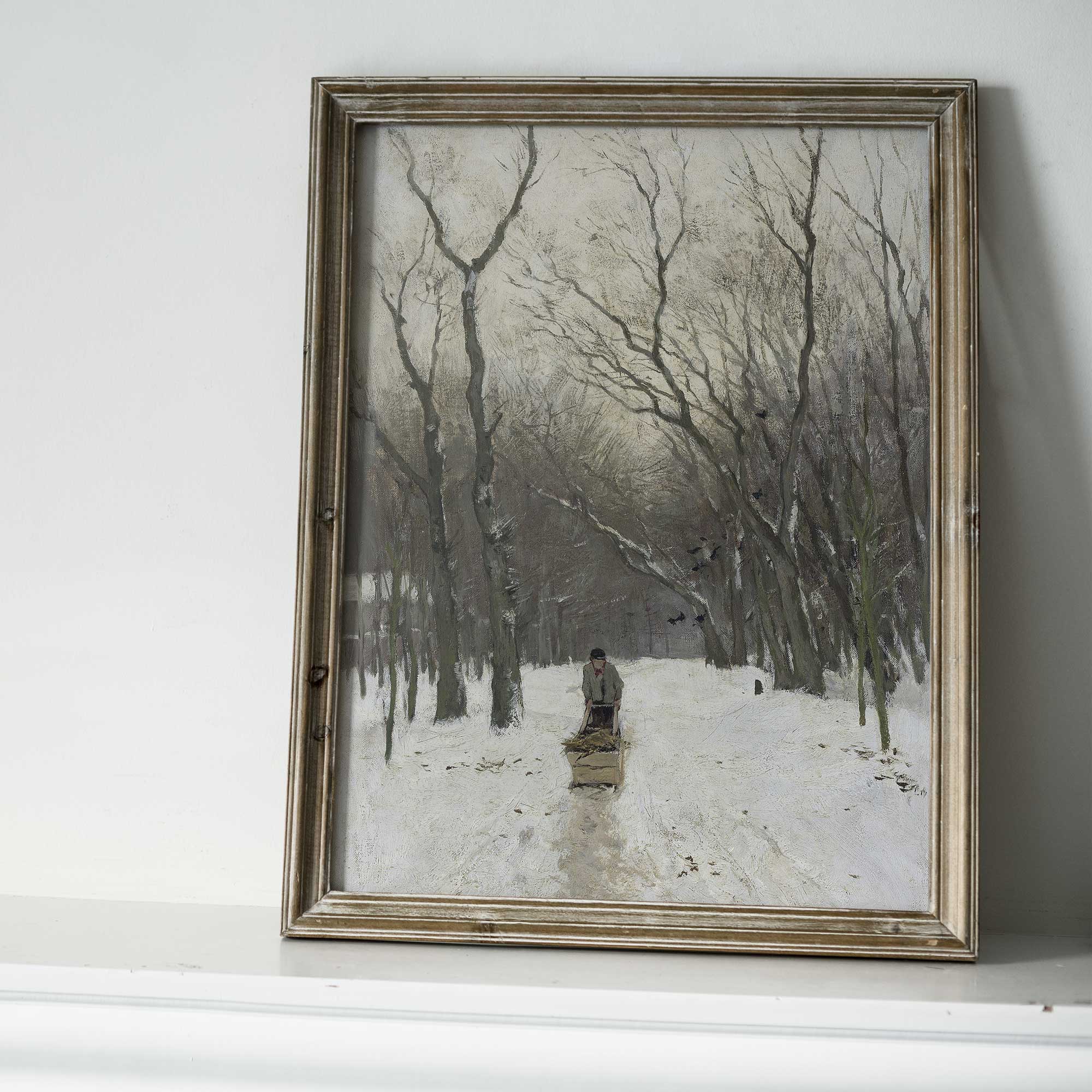 Framed artwork of a snowy landscape with trees and a person walking.