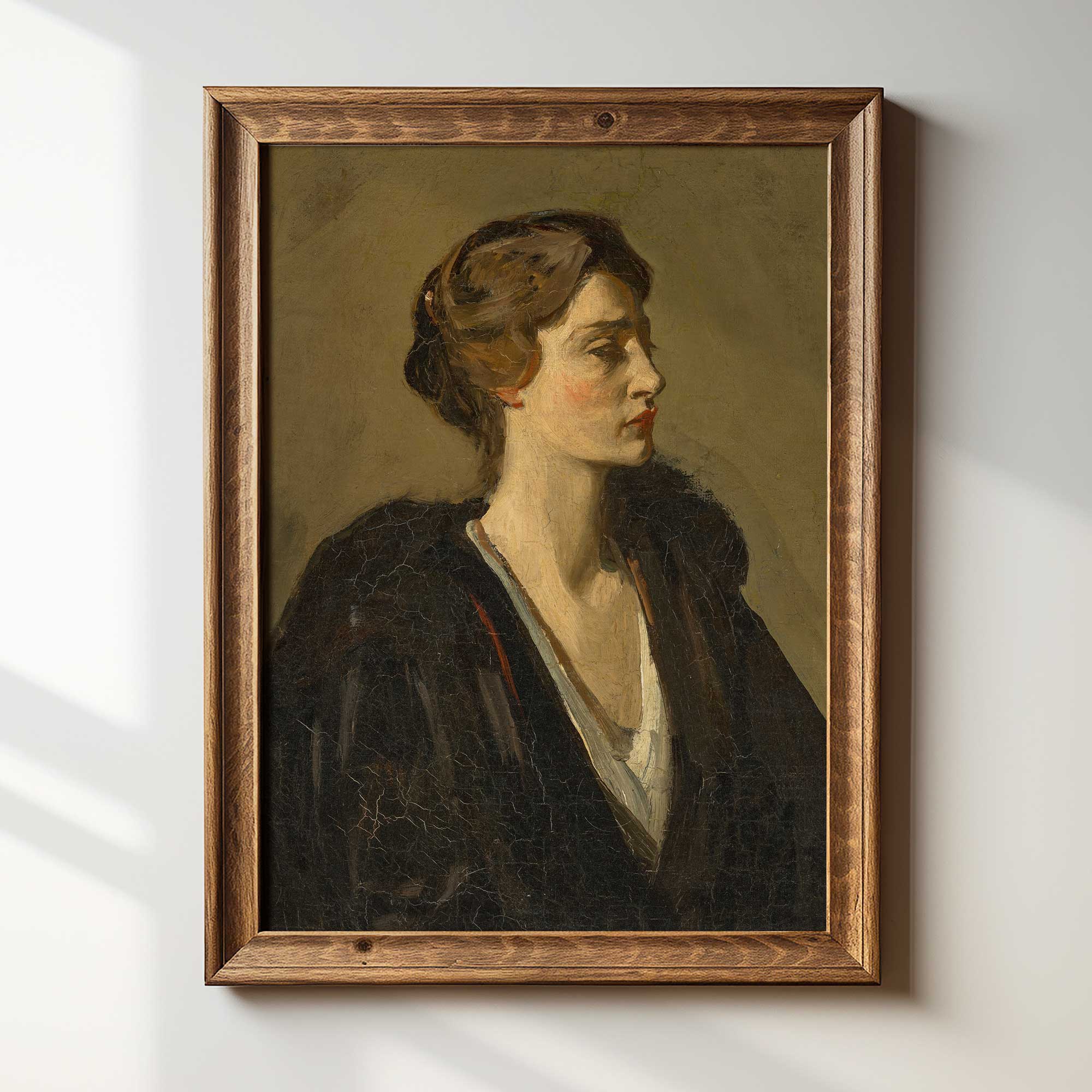 Framed portrait painting of a woman on a white wall