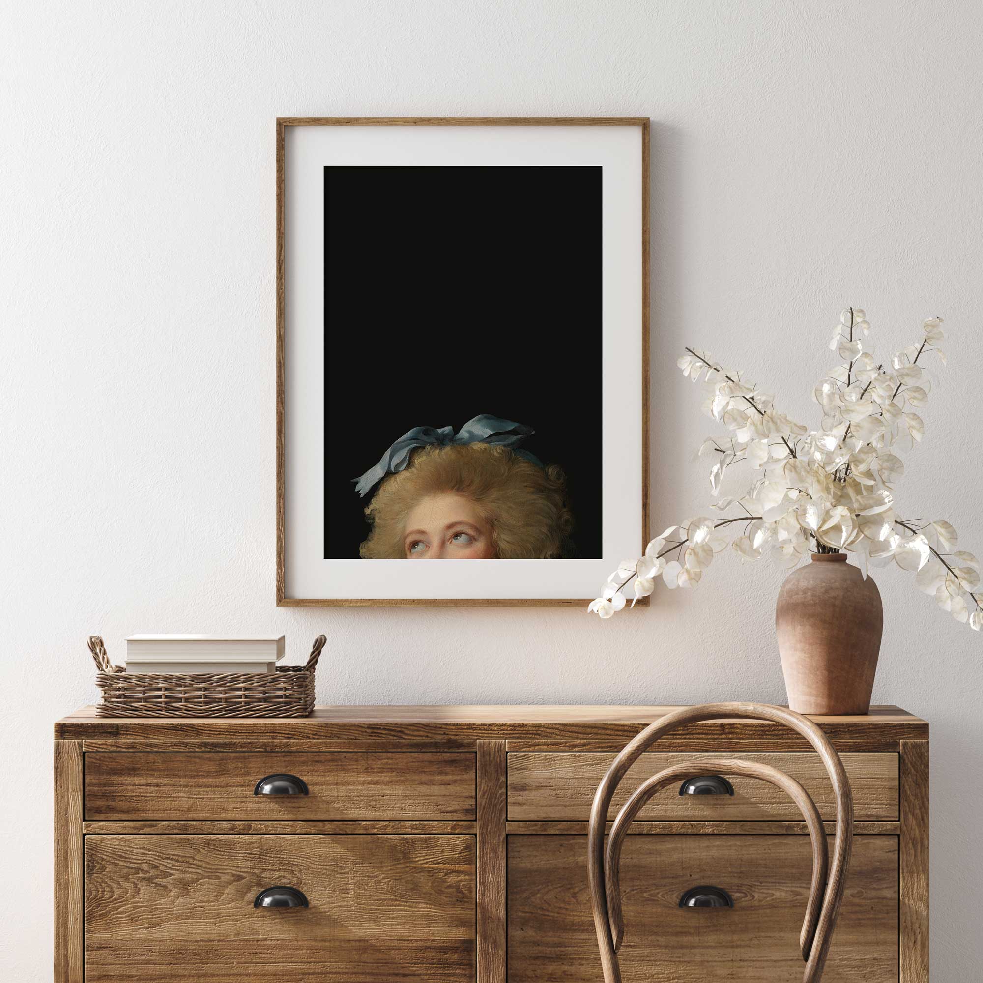 Framed Eclectic Vintage Portrait Print on a wall above a wooden dresser with decorative items.