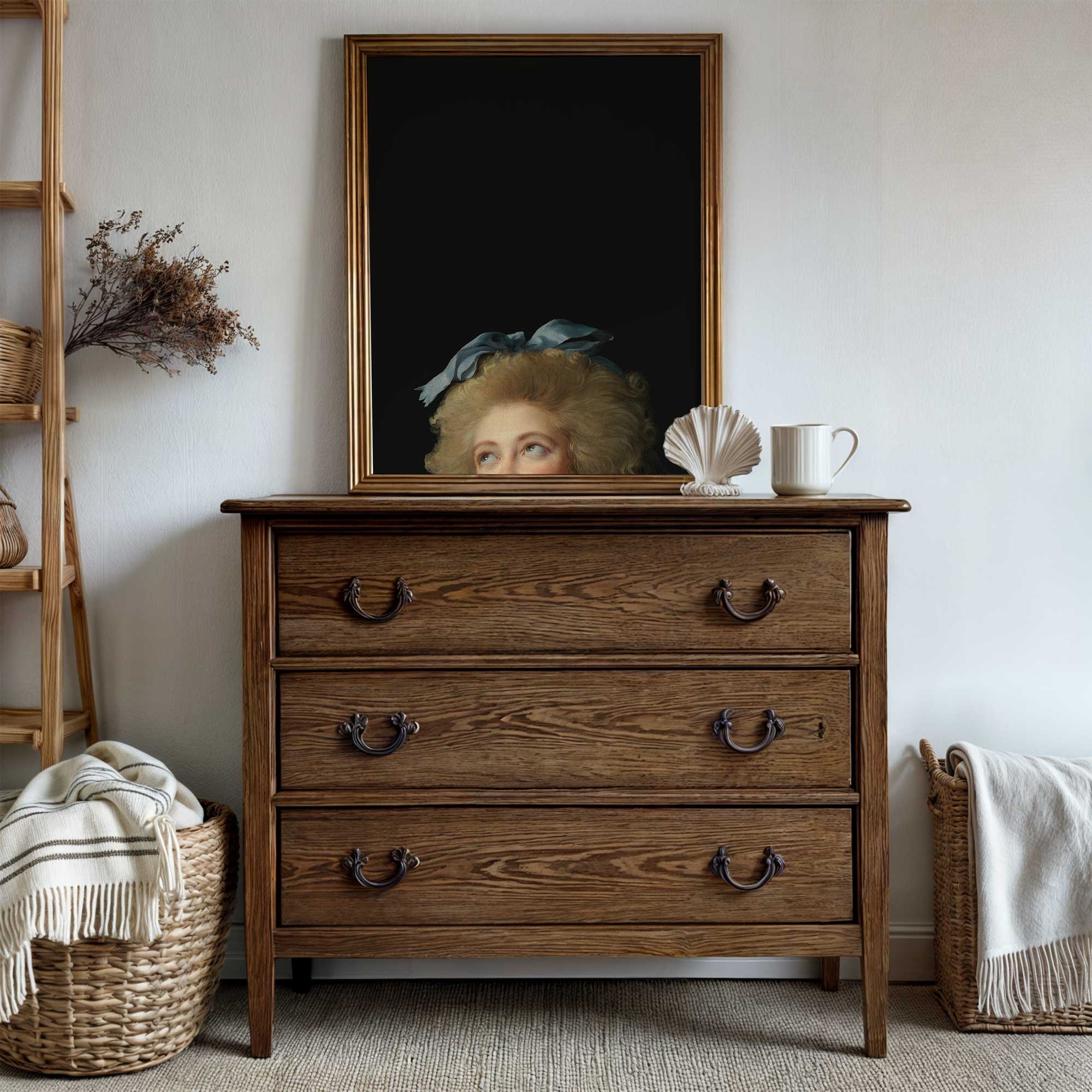 Wooden dresser with a framed Eclectic Vintage Portrait Print above it in a room setting.