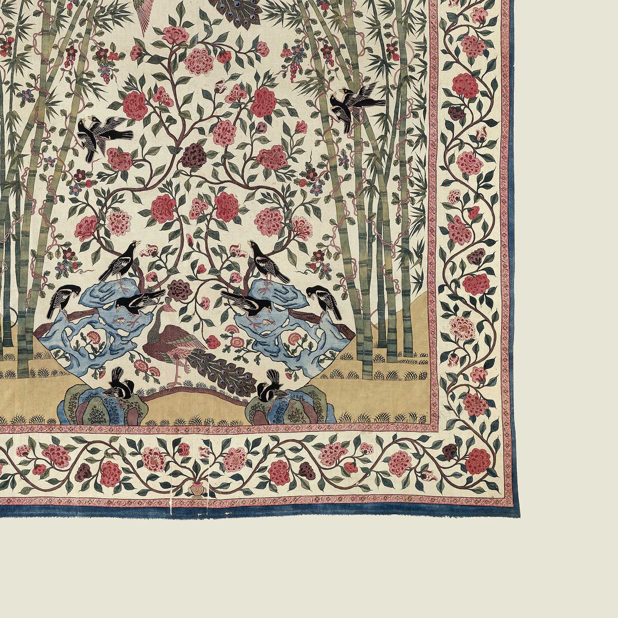 Detailed close-up of vintage bird and floral textile pattern with bamboo and flowers.
