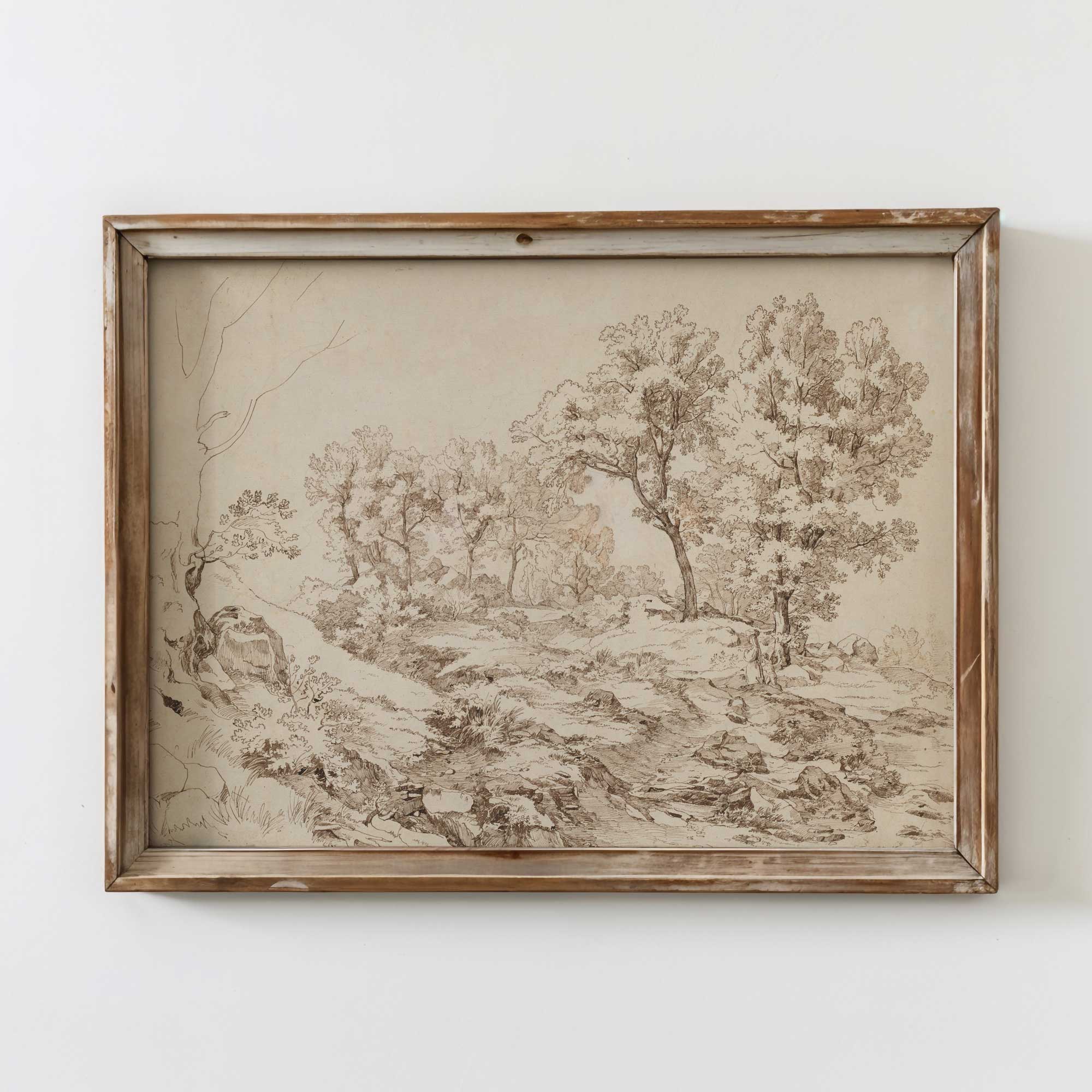 Framed landscape drawing on a white wall