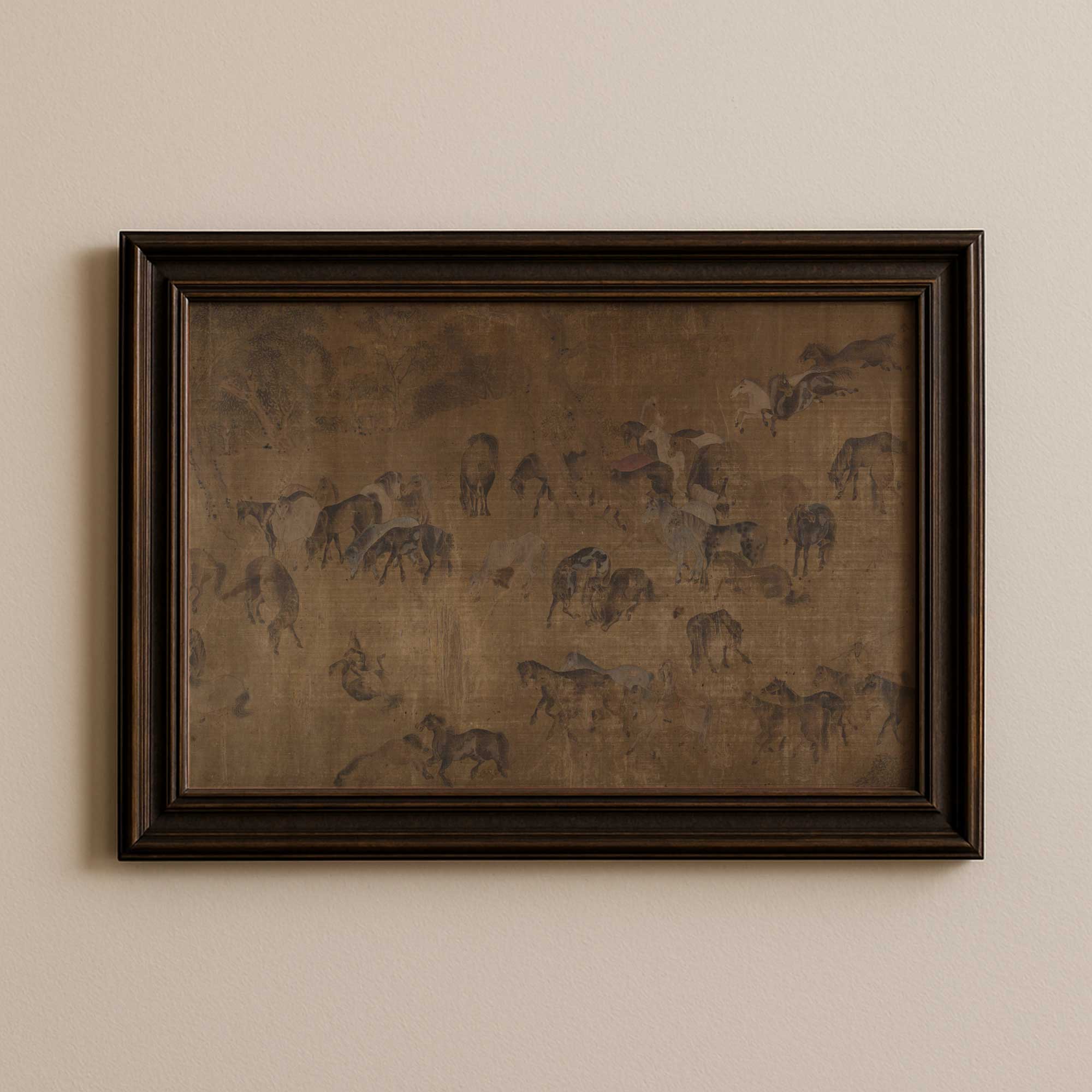 Framed artwork of the hundred horses in moody tones on a beige wall