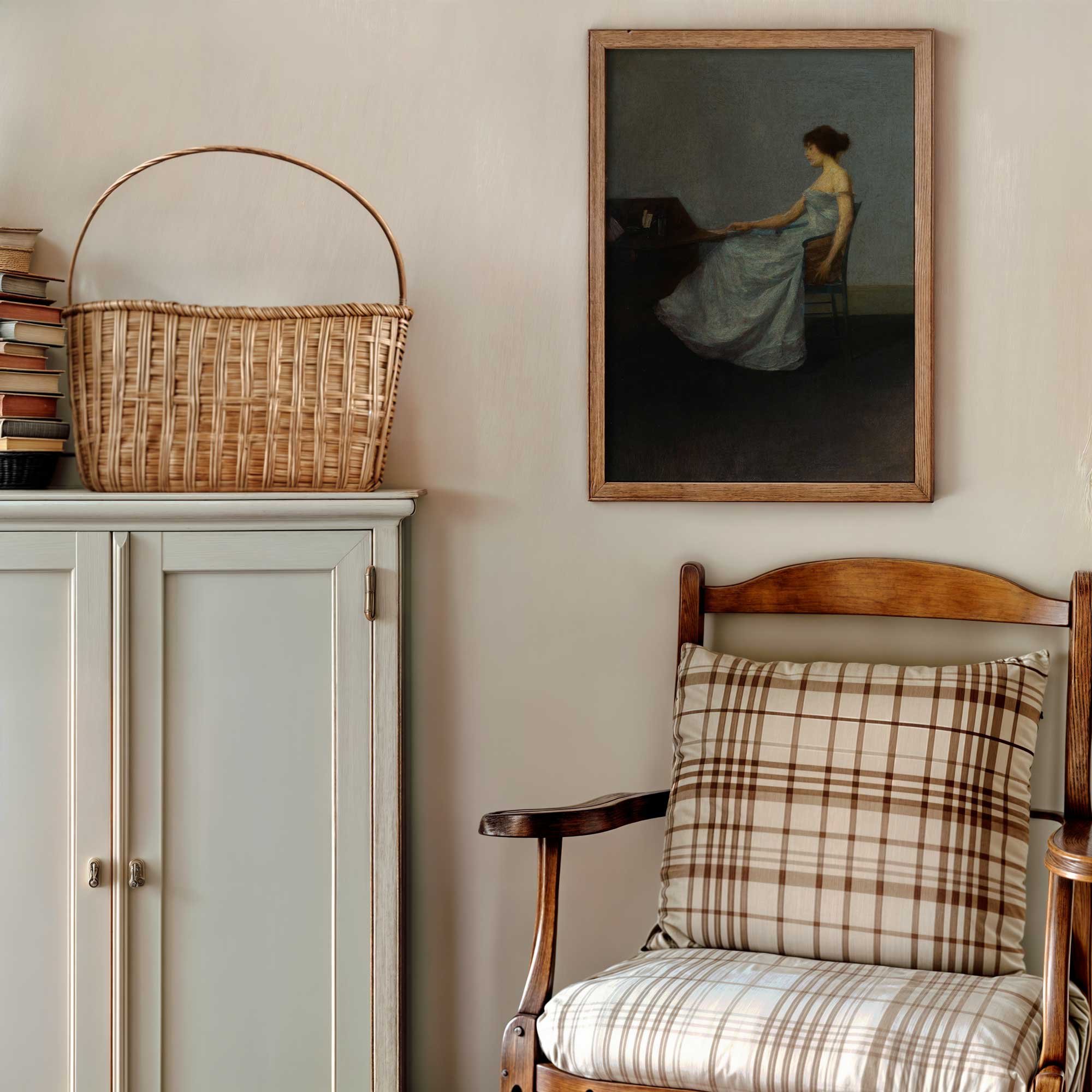 Nestled corner with a wooden chair, basket on a cabinet, and framed moody woman painting on the wall.