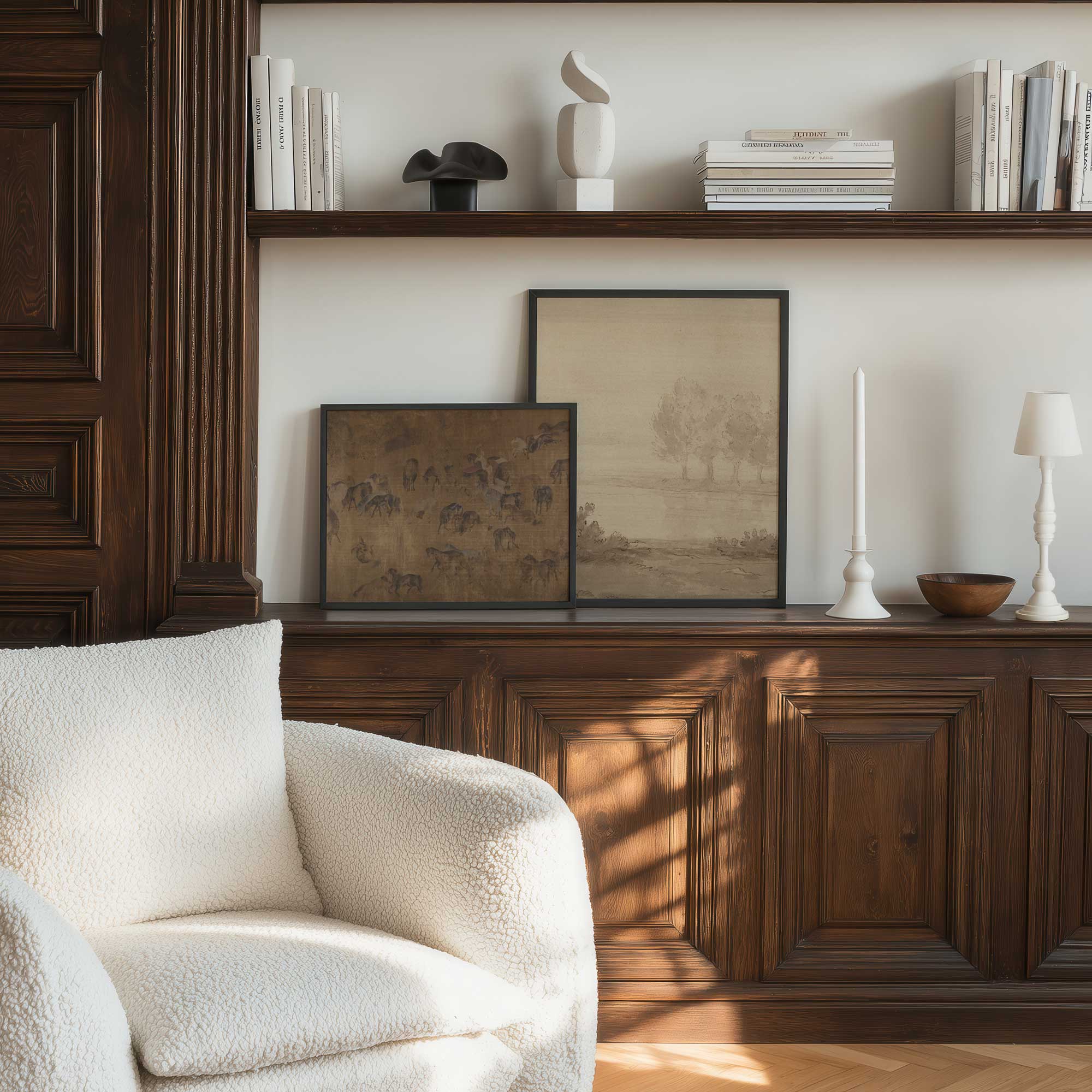 Living room with a white armchair, wooden cabinet, two framed Vintage Moody Wall Art