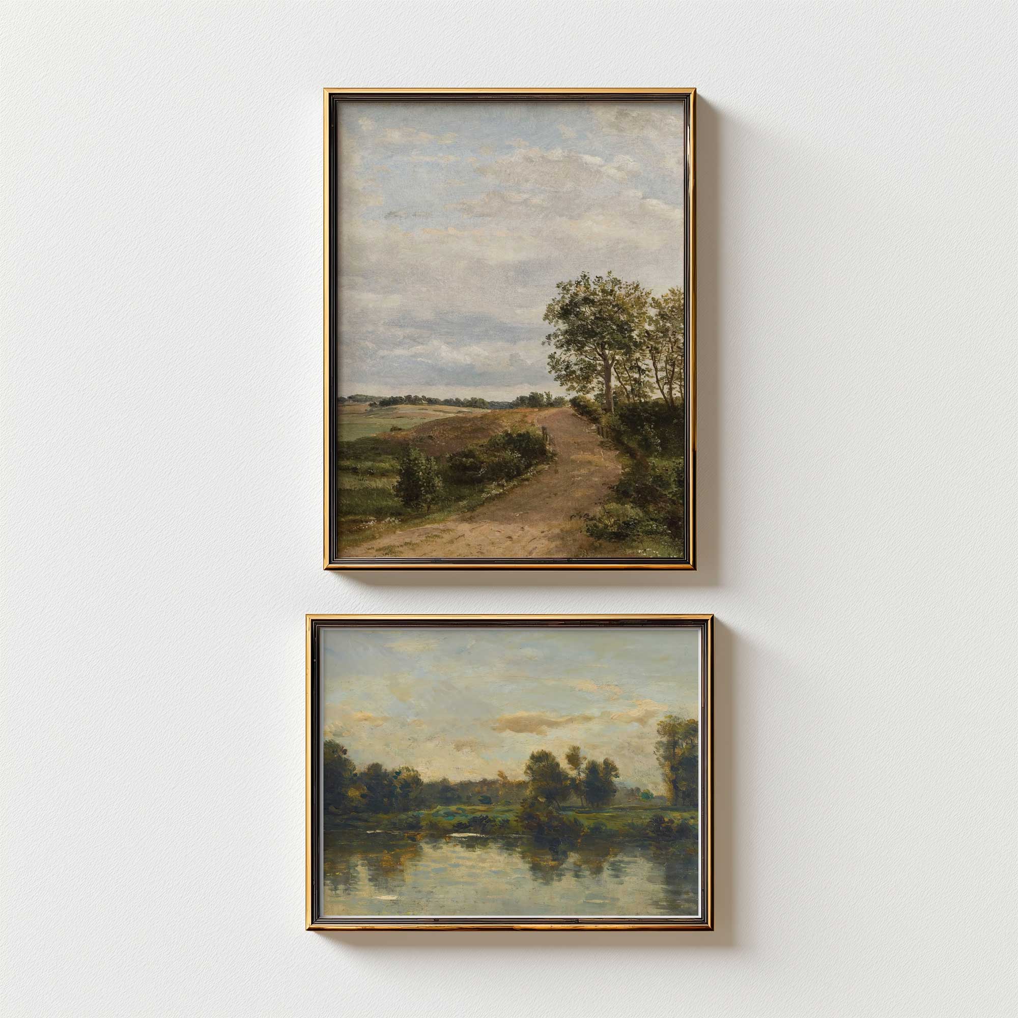 Two framed landscape paintings on a white wall.