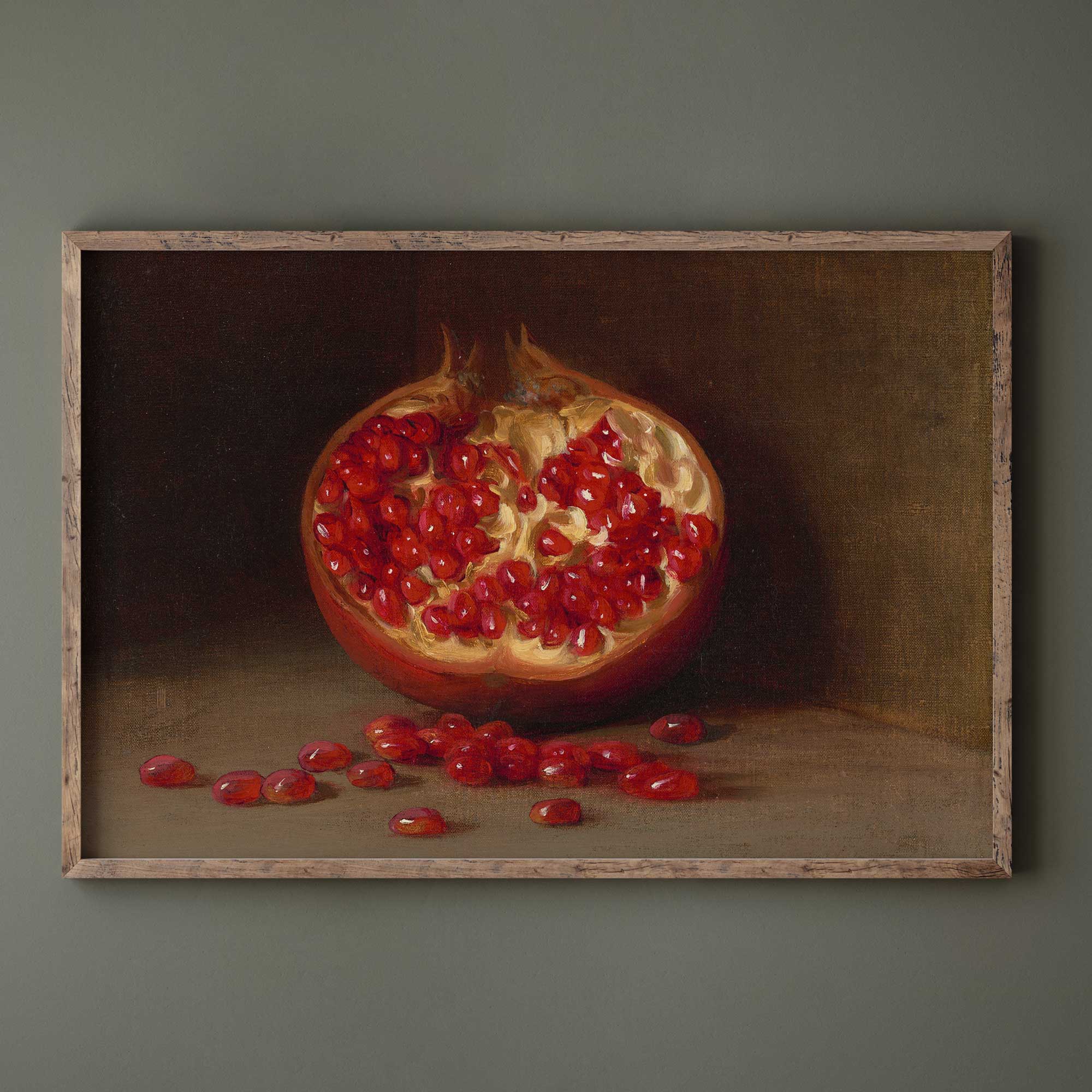 Framed painting of a pomegranate with seeds on a dark background
