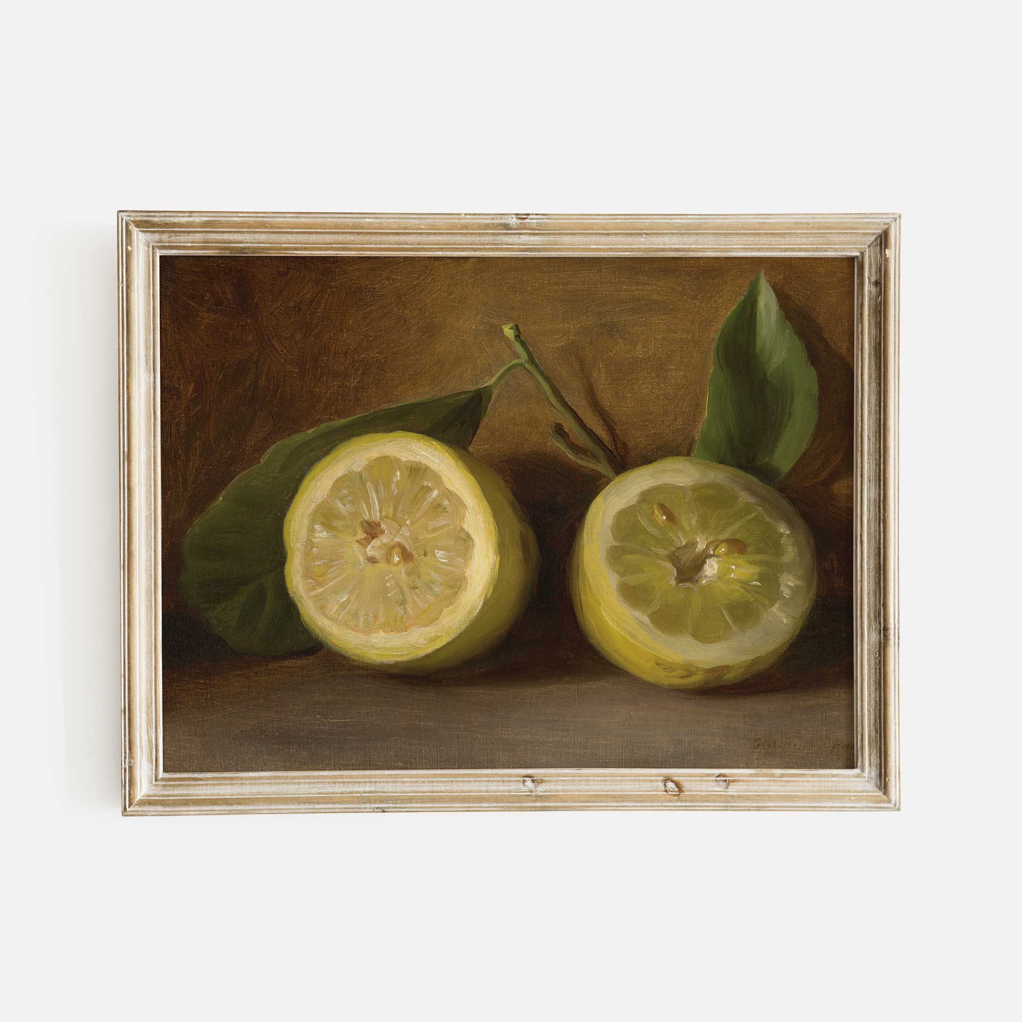 Framed painting of two lemons with leaves on a brown background