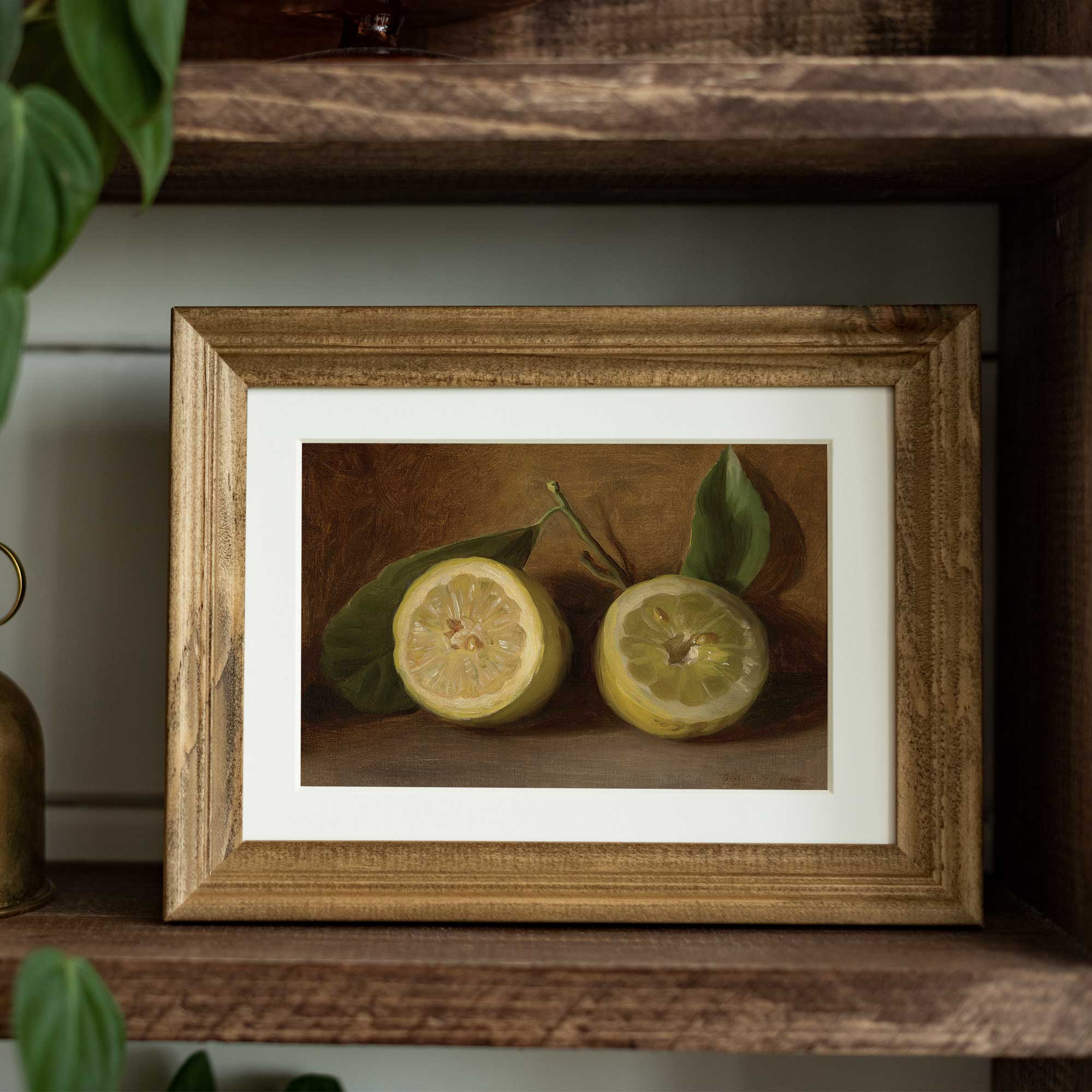 Framed still life painting of lemons on a wooden shelf