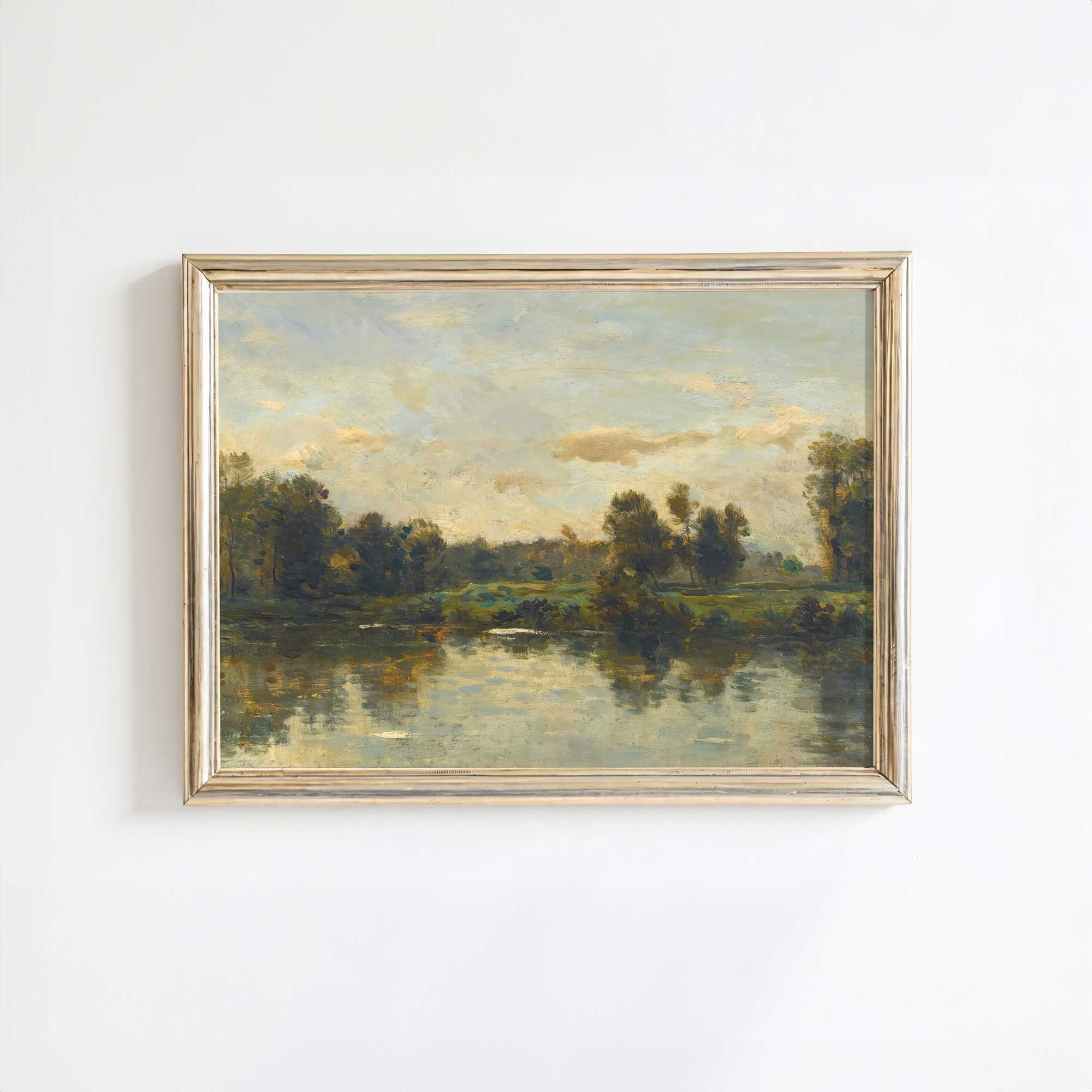 Framed landscape painting of a river and trees on a white wall