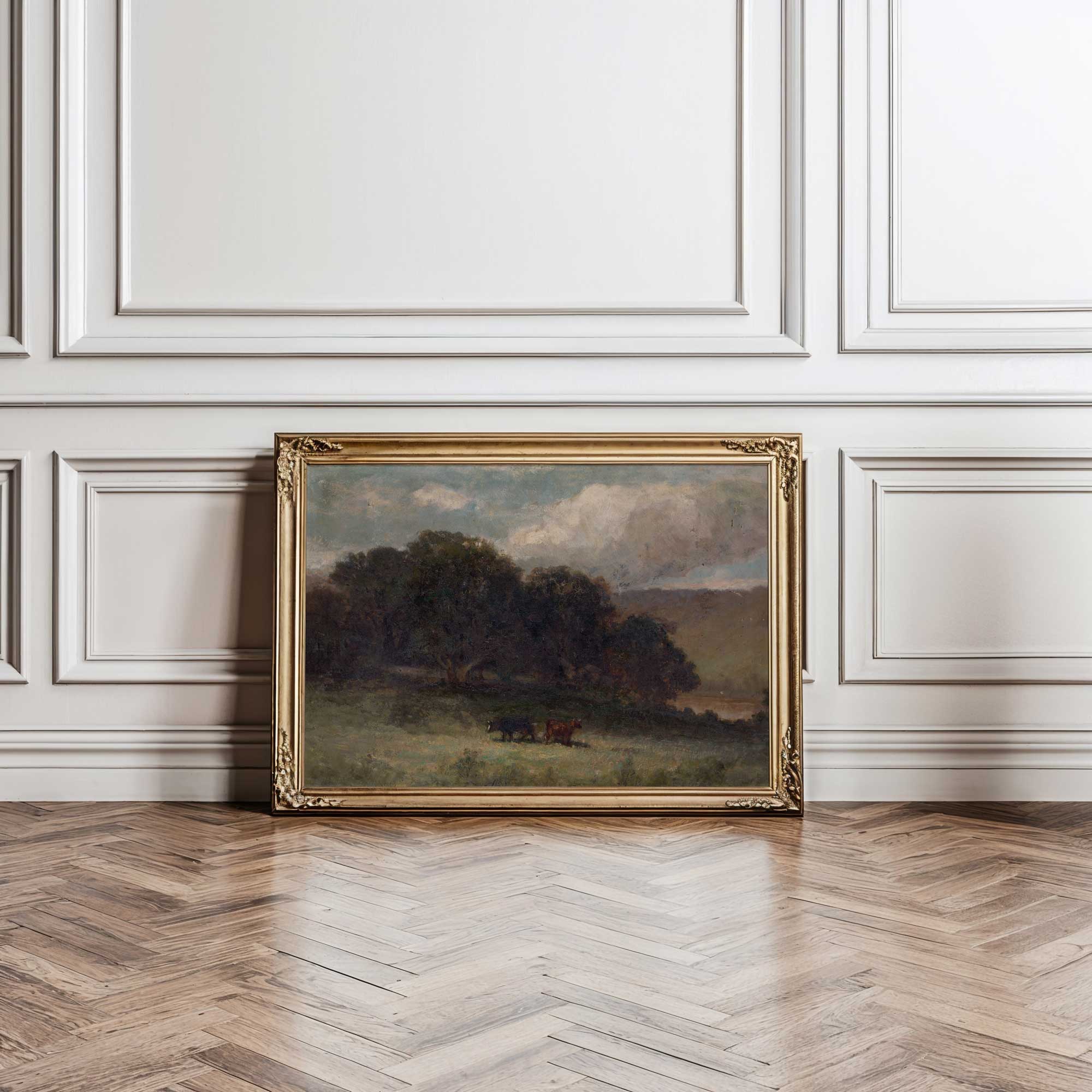 Dark country landscape wall art in ornate vintage frame leaning against classic panelled wall decor