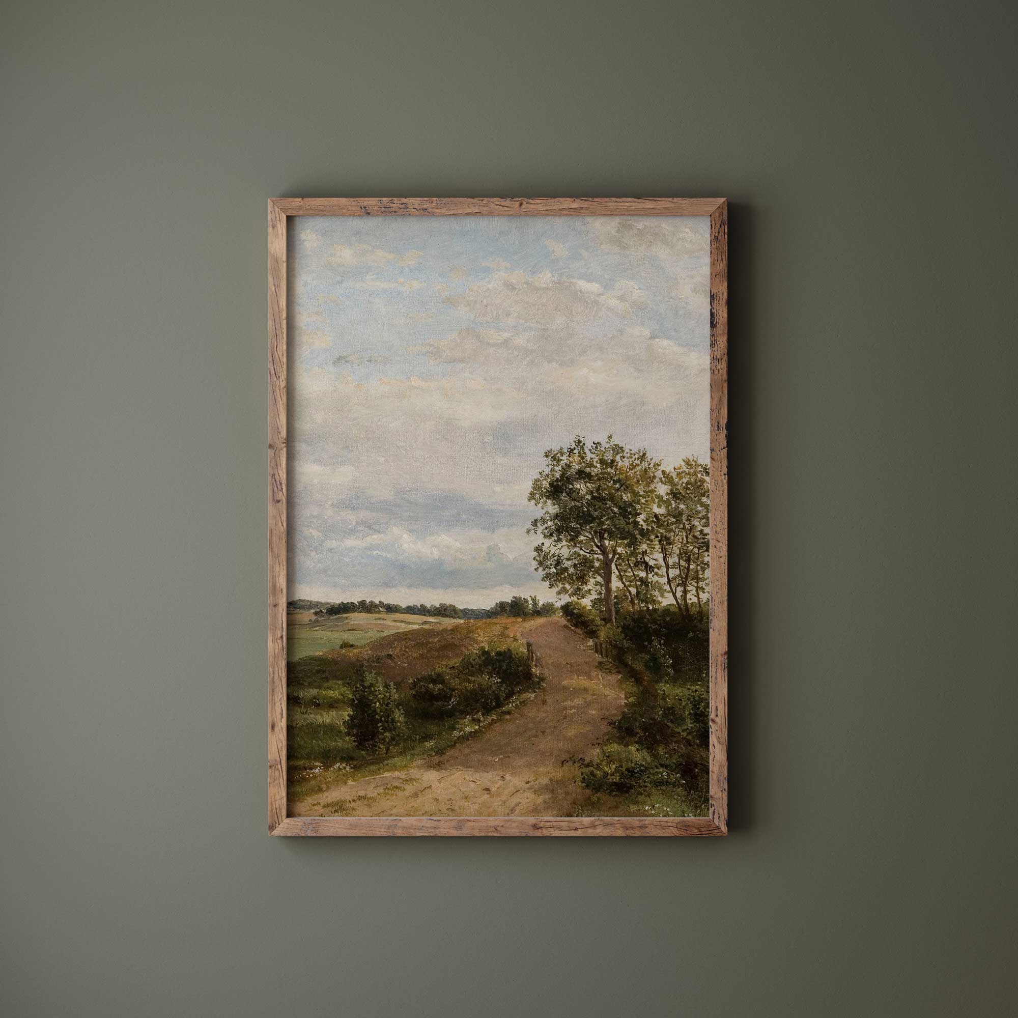 Vintage country landscape print in driftwood frame on sage green wall — farmhouse wall art