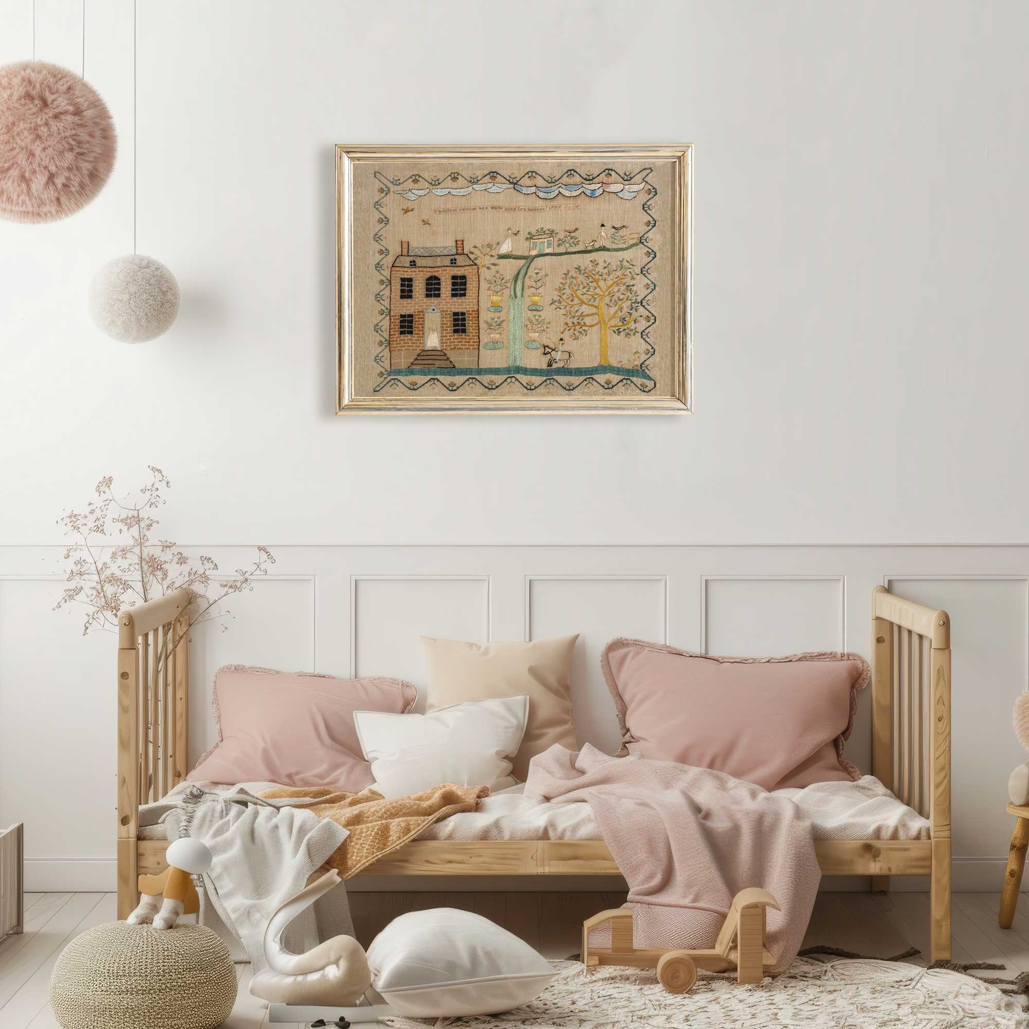 Whimsical folk art house print in gold frame displayed in the Nursery