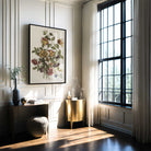 Modern interior with a desk, floral artwork, and large window.