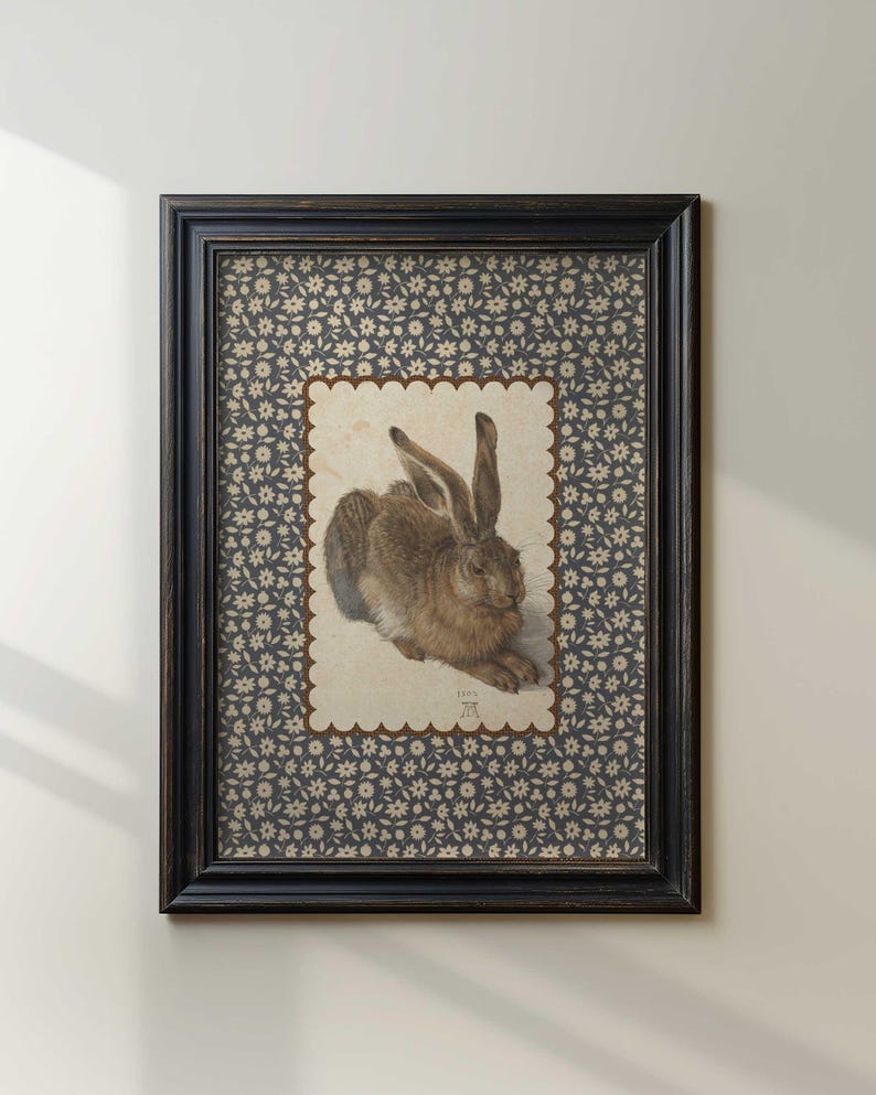 Hare art print with scalloped border in vintage frame against white wall.