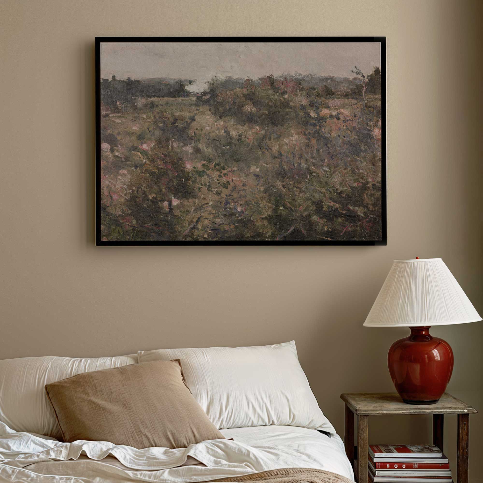 Framed French Meadow Field Landscape Print above a bed with a lamp on a nightstand.