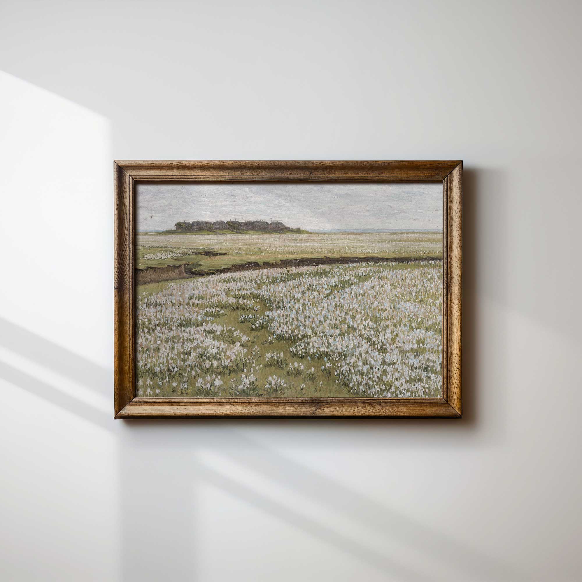 Framed painting of a Blooming Floral Meadow landscape on a white wall