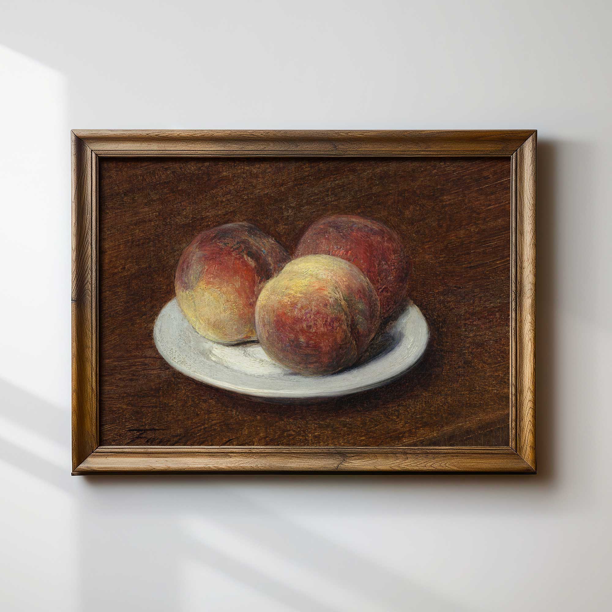 Framed painting of peaches on a white plate against a white wall