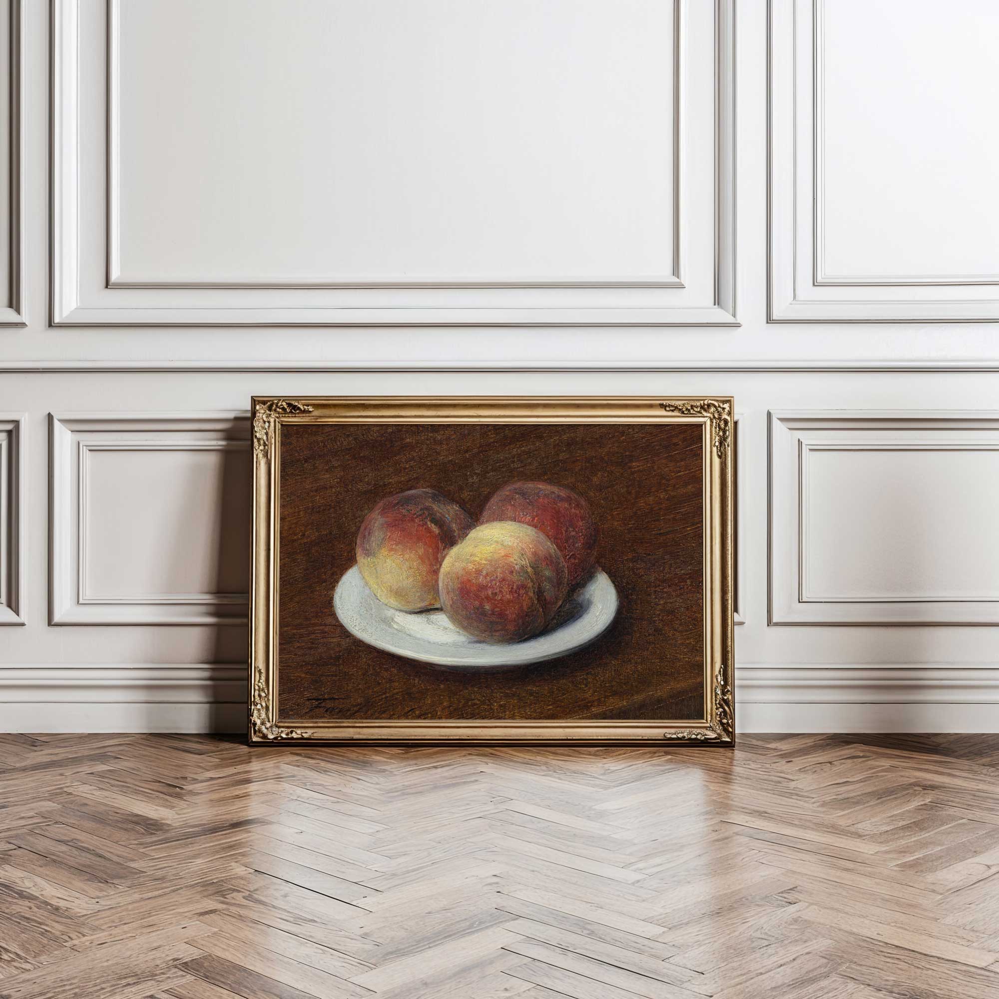 Framed painting of peaches on a white plate against a white wall.