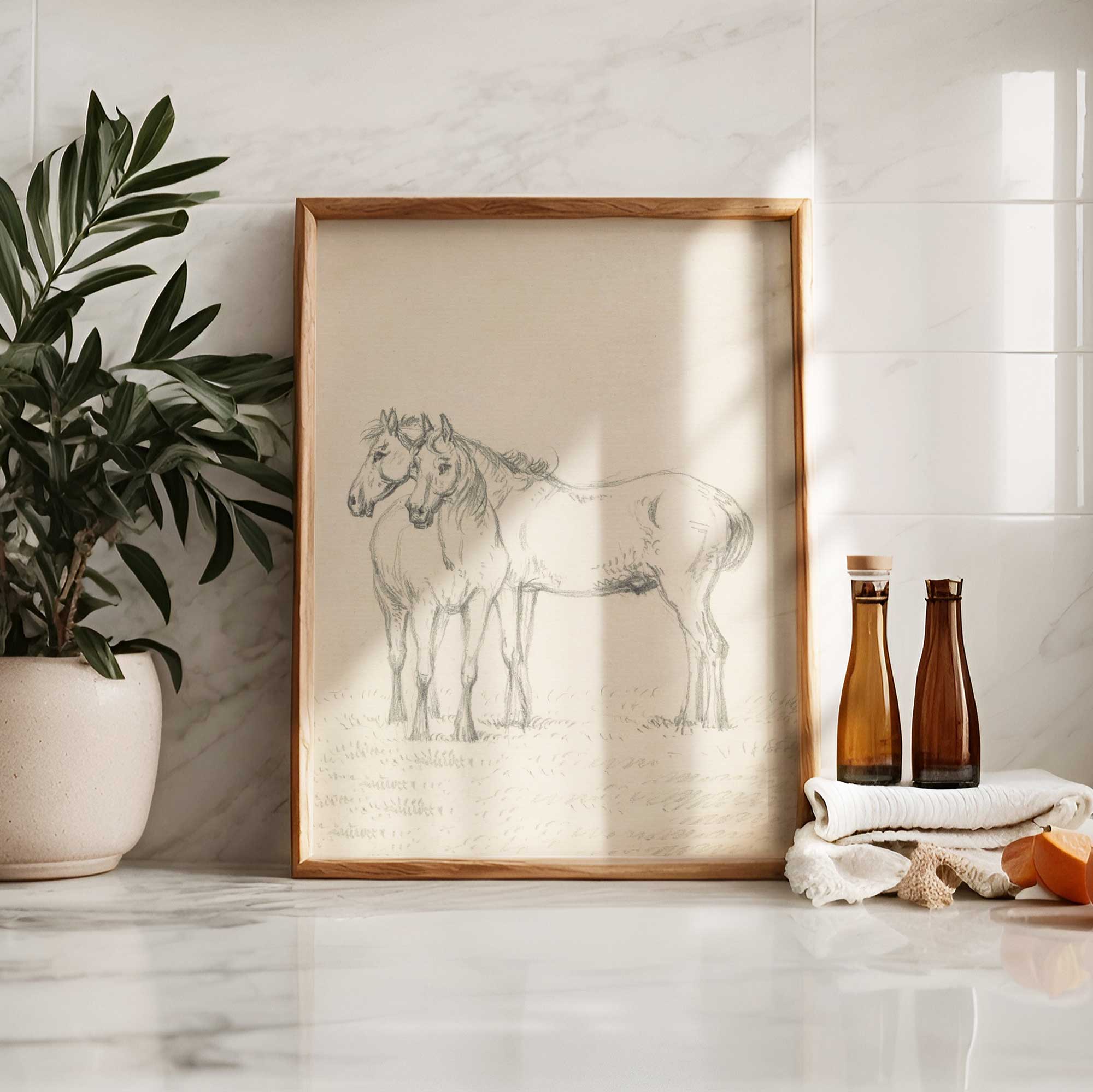 Framed artwork of two horses on a marble surface with decorative items.