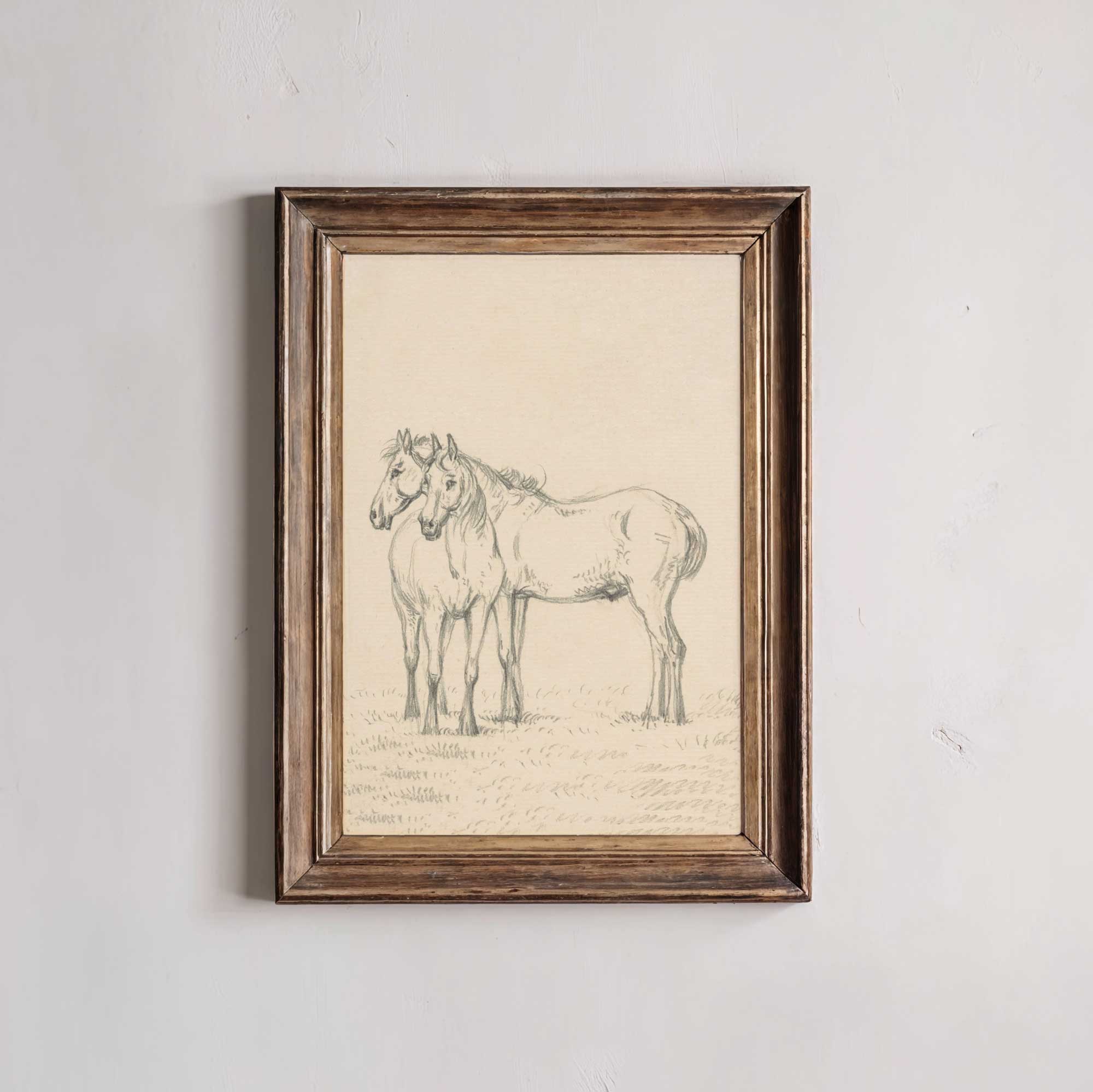 Framed artwork of two horses on a textured wall