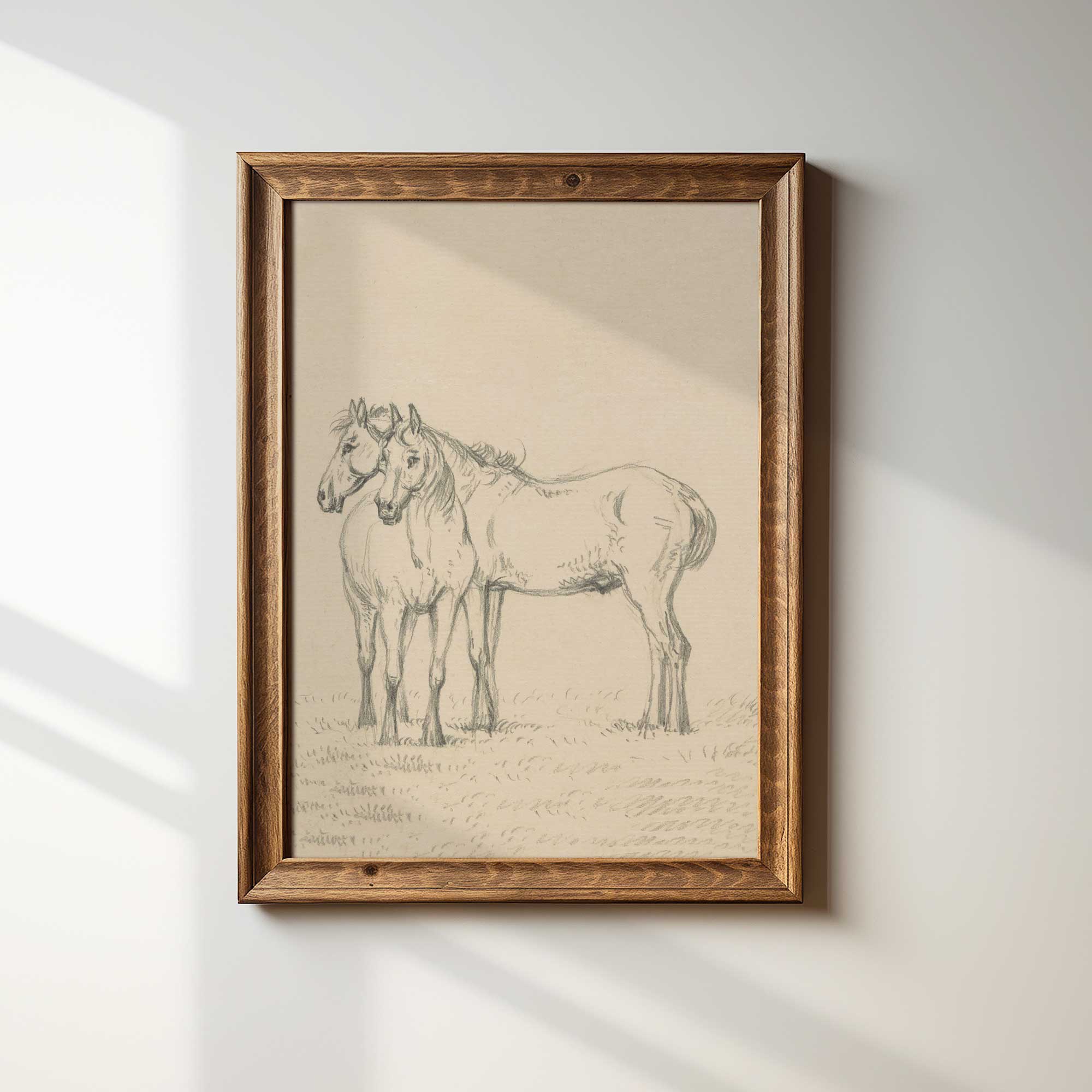Framed artwork of two horses on a light background