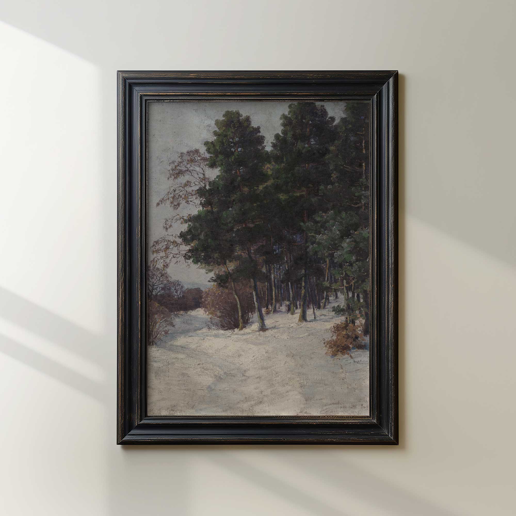 Framed painting of a forest scene on a white wall