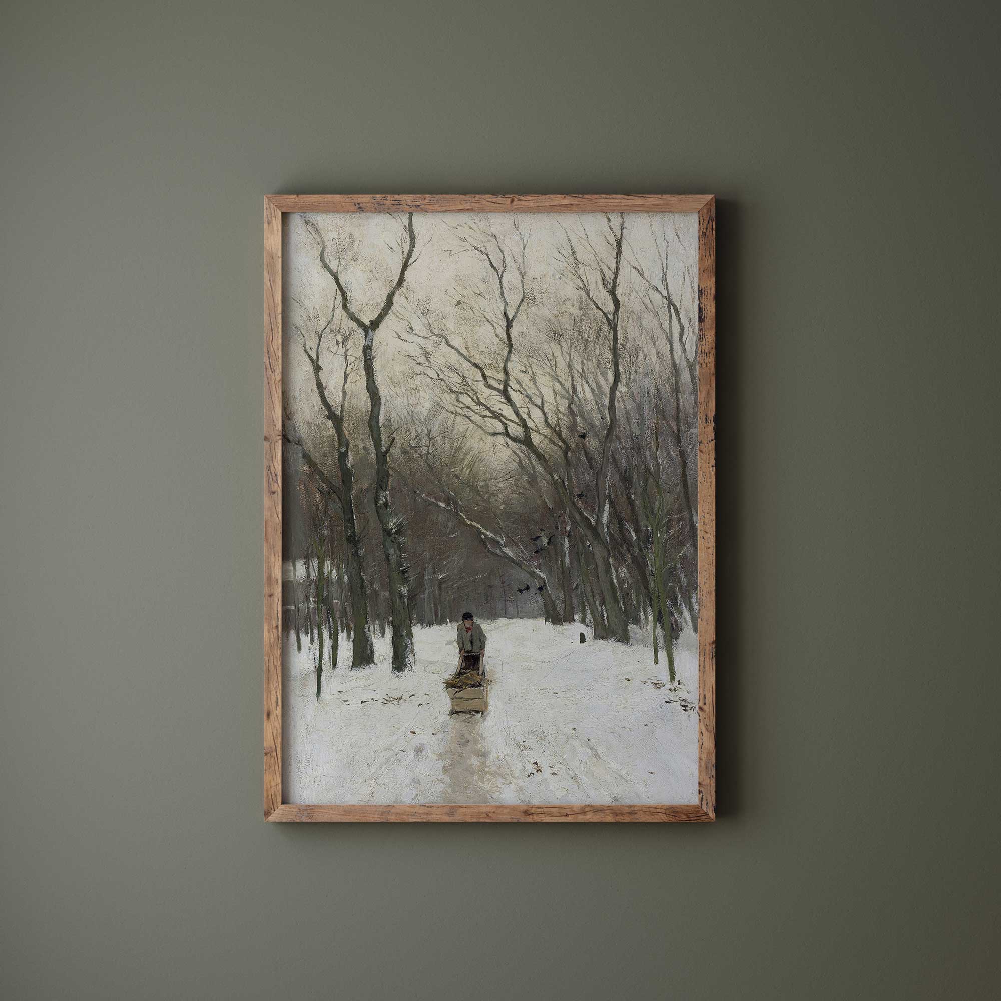 Framed artwork of a snowy landscape with trees and a person on a path, on a green wall.