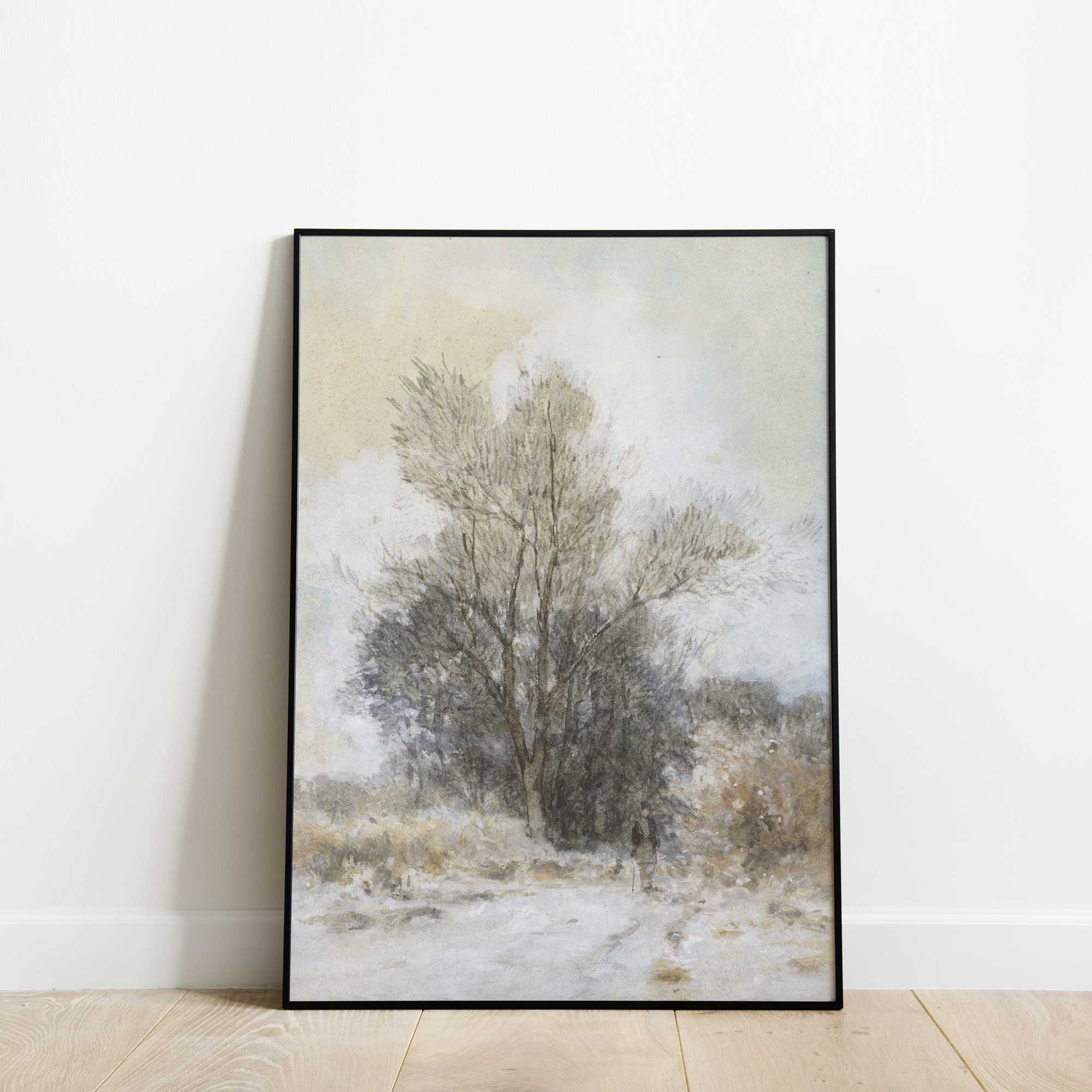 Framed artwork of a winter landscape with trees on a white wall.
