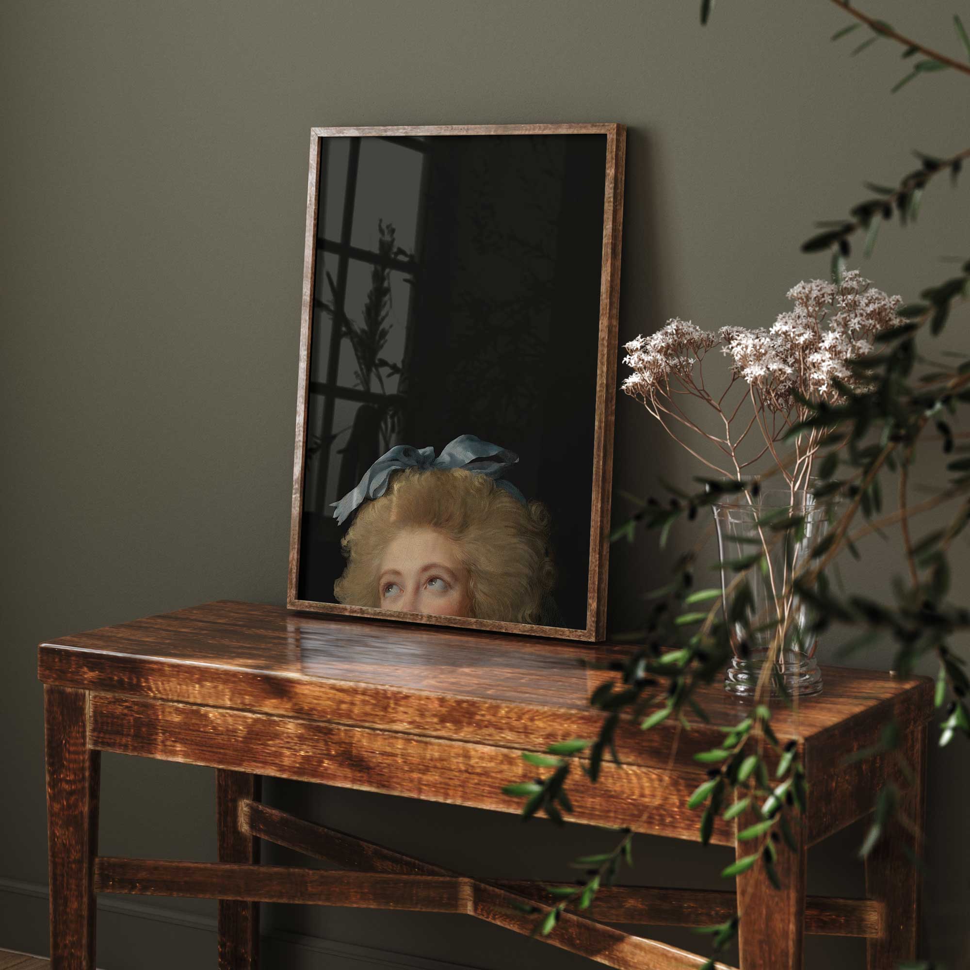 Framed Eclectic Vintage Portrait Print on a wooden table with plants in the foreground