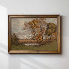 Framed autumn vintage landscape print  of trees and a river on a white wall