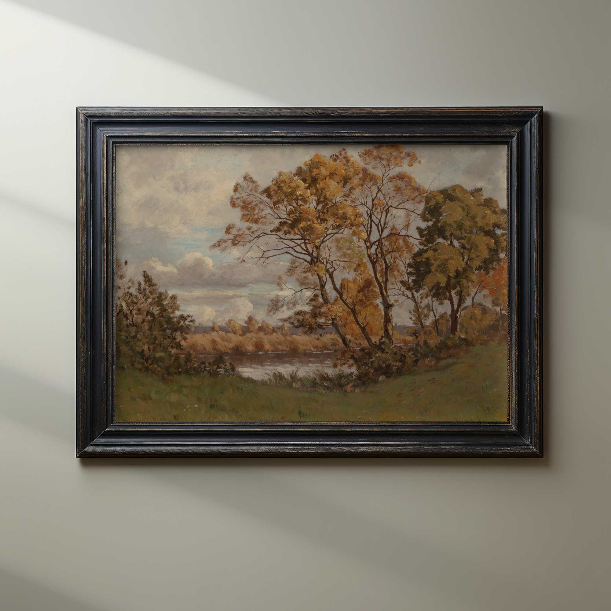 Framed autumn vintage landscape print  of trees and a lake on a beige wall