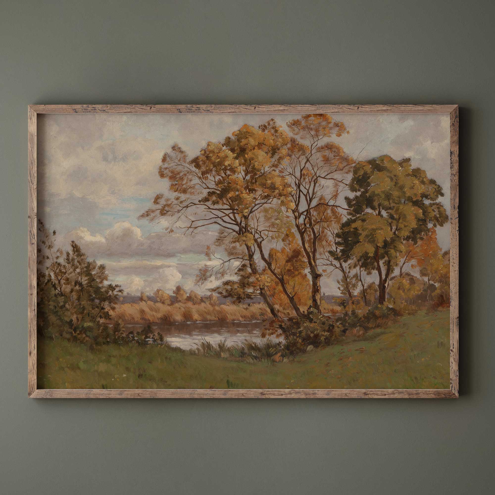 Framed painting of a autumn vintage landscape print with trees and a river on a green wall.