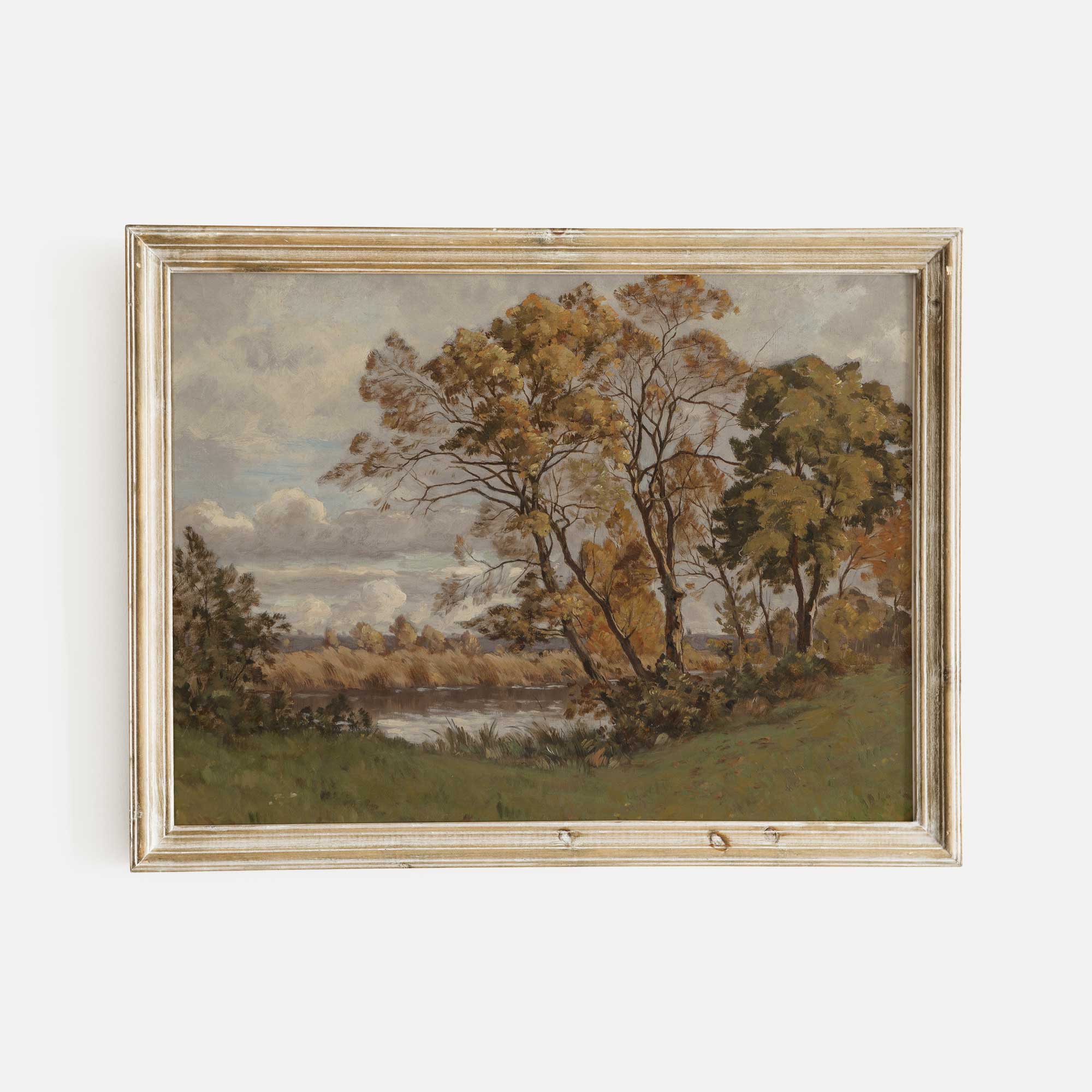 Framed Autumn vintage landscape painting of trees by a lake on a white wall
