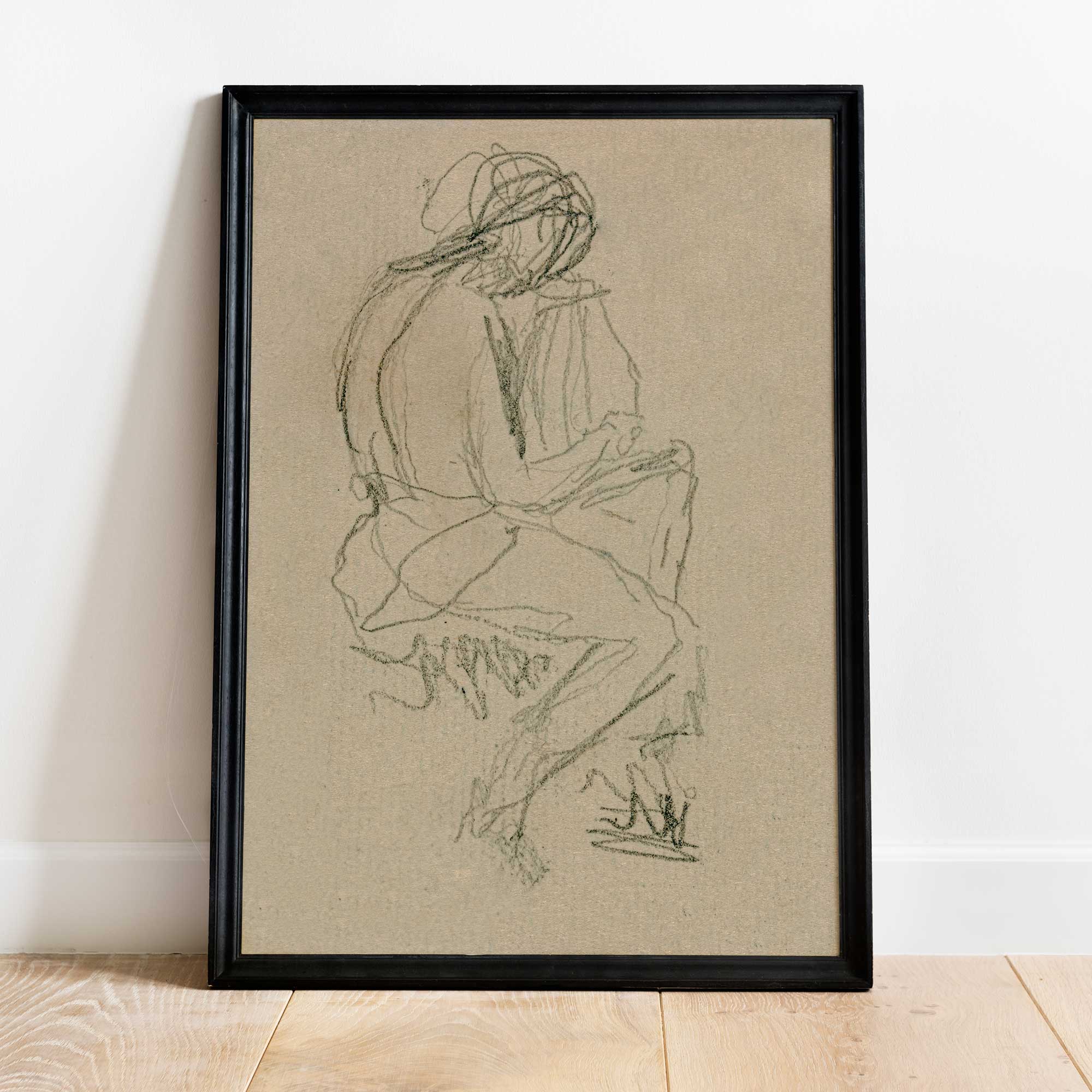 Figure study wall art print — abstract line drawing in neutral tones, framed in black and leaning against a wall.