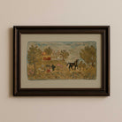 Framed hooked rug nursery print with a pastoral scene of a house, trees, and animals on a beige wall.