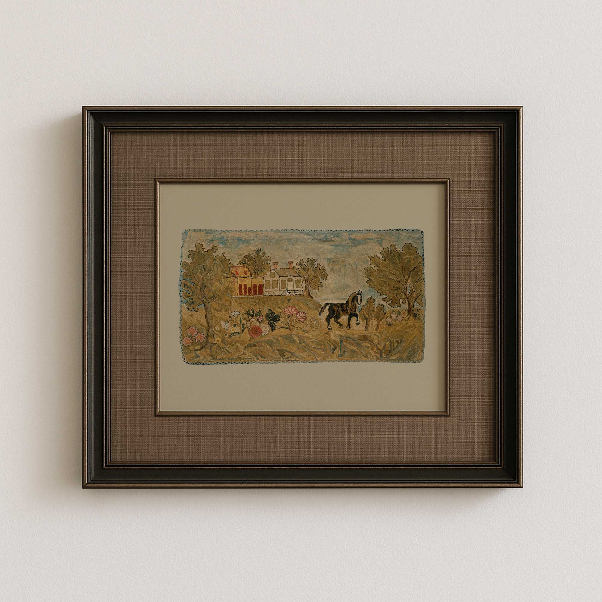 Framed hooked rug nursery wall art on a white wall