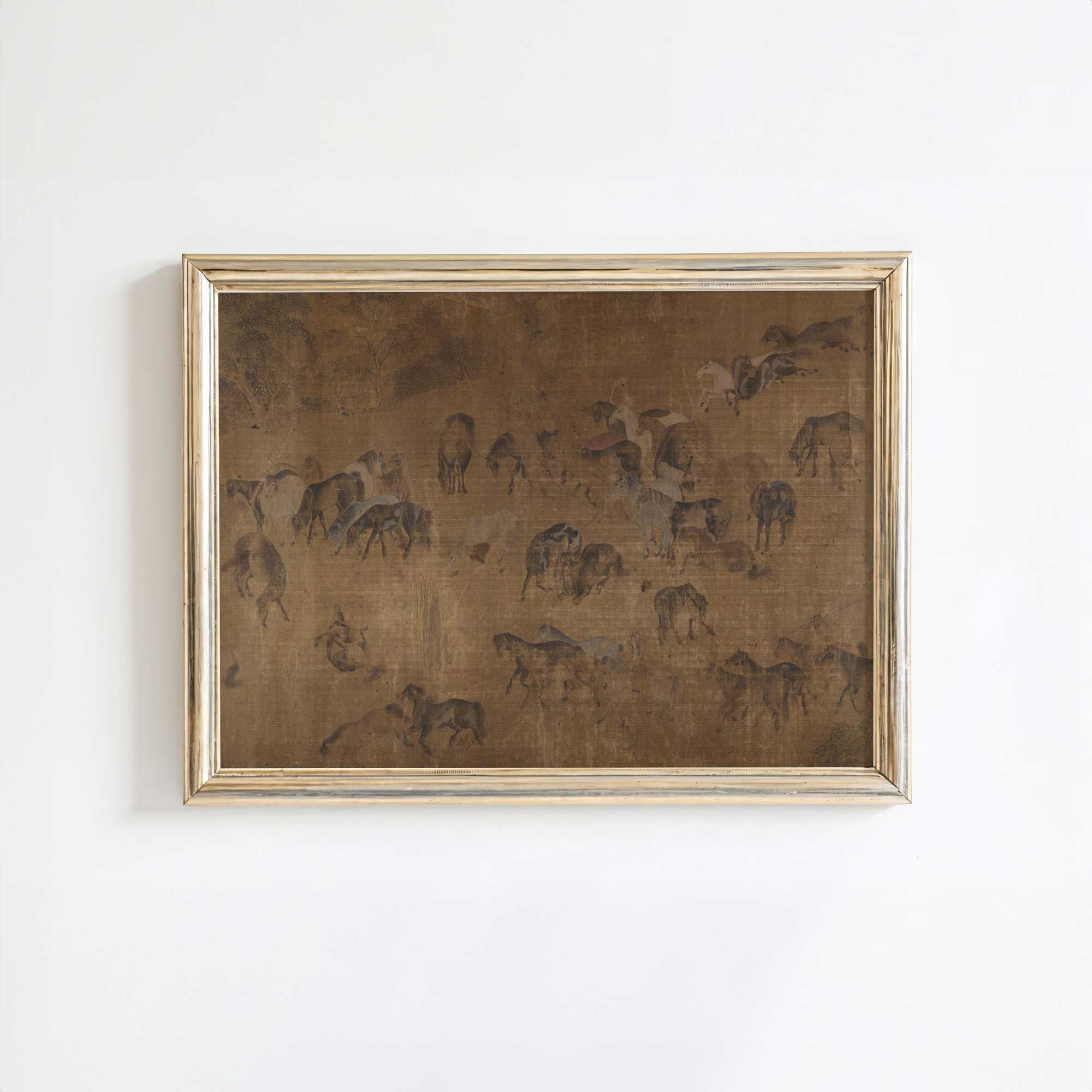 Framed artwork of horses on a white wall