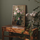 Floral painting on a wooden table against a dark green wall