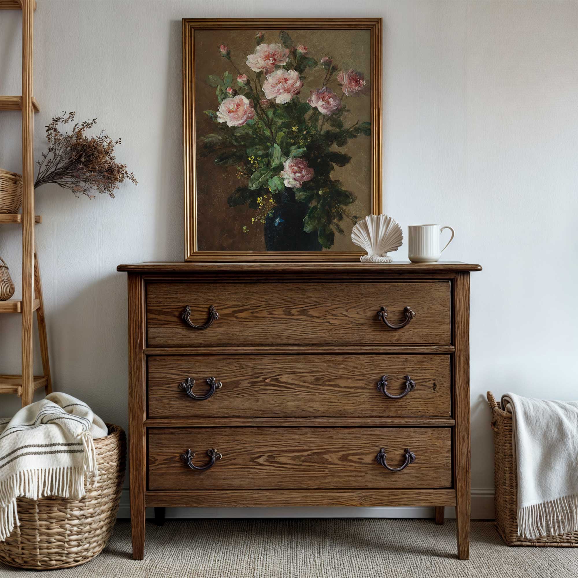 Wooden dresser with floral painting above, wicker baskets on either side, and a white wall background.