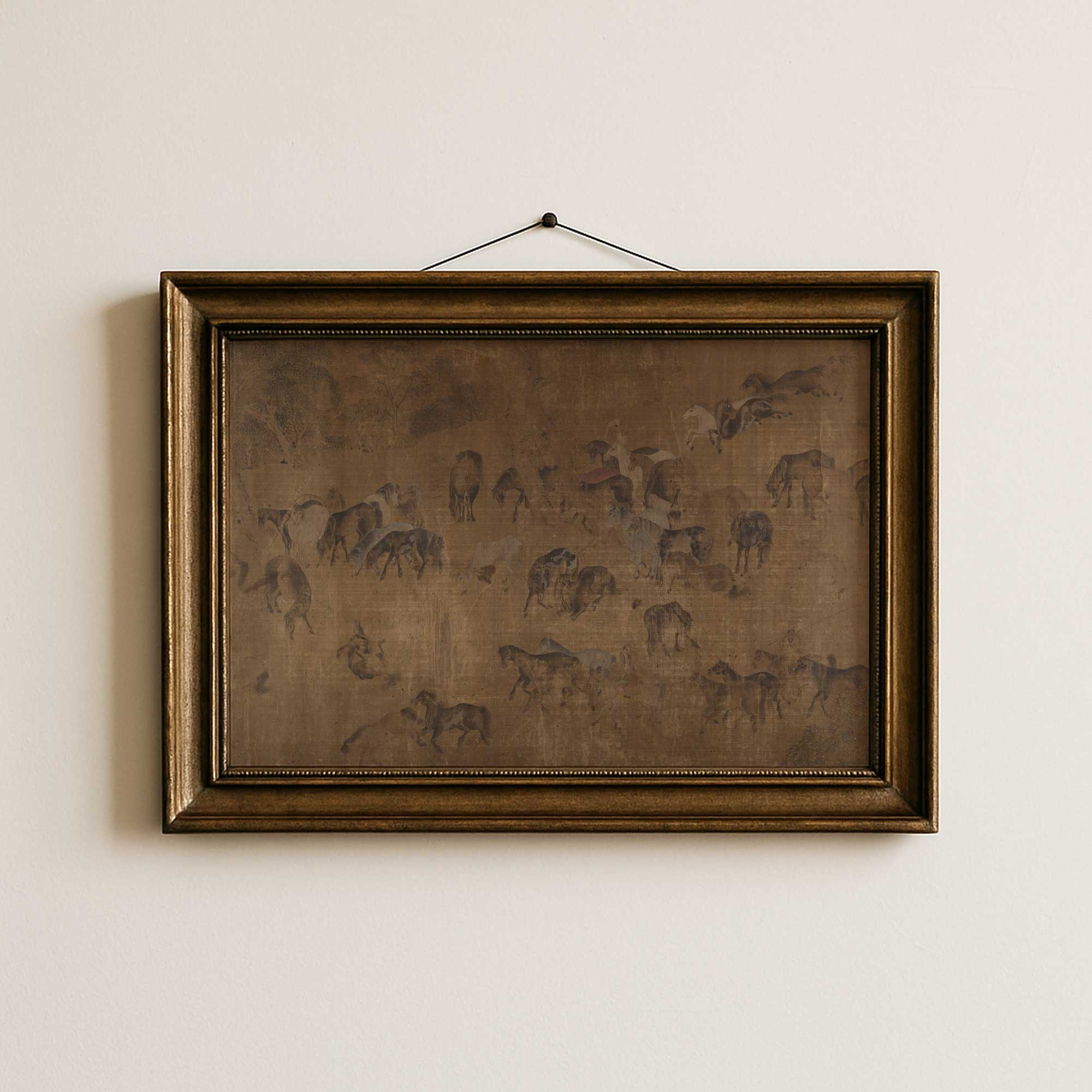 Framed artwork of The Hundred Horses, Moody Vintage Print on a beige wall