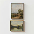 Two framed landscape paintings on a white wall.