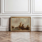 Framed painting of sailboats on a wall with wooden floor