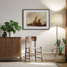 Living room with wooden cabinet, chair, floor lamp, and framed artwork on a wall.