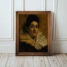 Framed dark oil portrait of a woman with a large ruffled collar on a wooden floor against a white panelled wall.