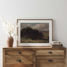 Dark country wall art displayed on a rustic farmhouse dresser with white floral arrangement and woven basket