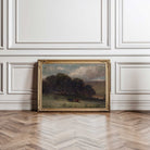 Dark country landscape wall art in ornate vintage frame leaning against classic panelled wall decor