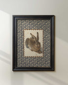 Black-framed woodland rabbit print with a decorative border.