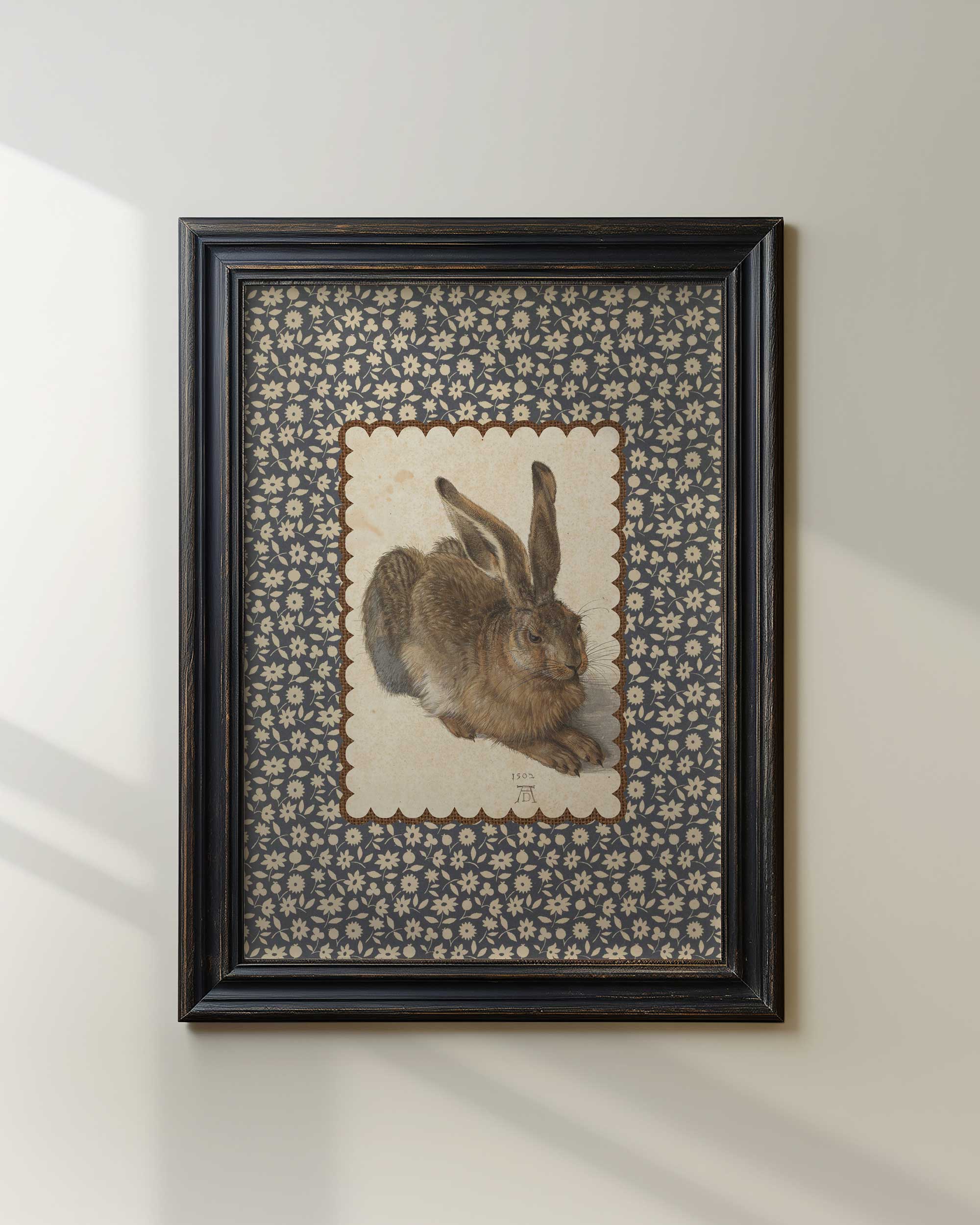 Black-framed woodland rabbit print with a decorative border.