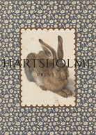 Vintage rabbit print with scalloped border and floral textile background.